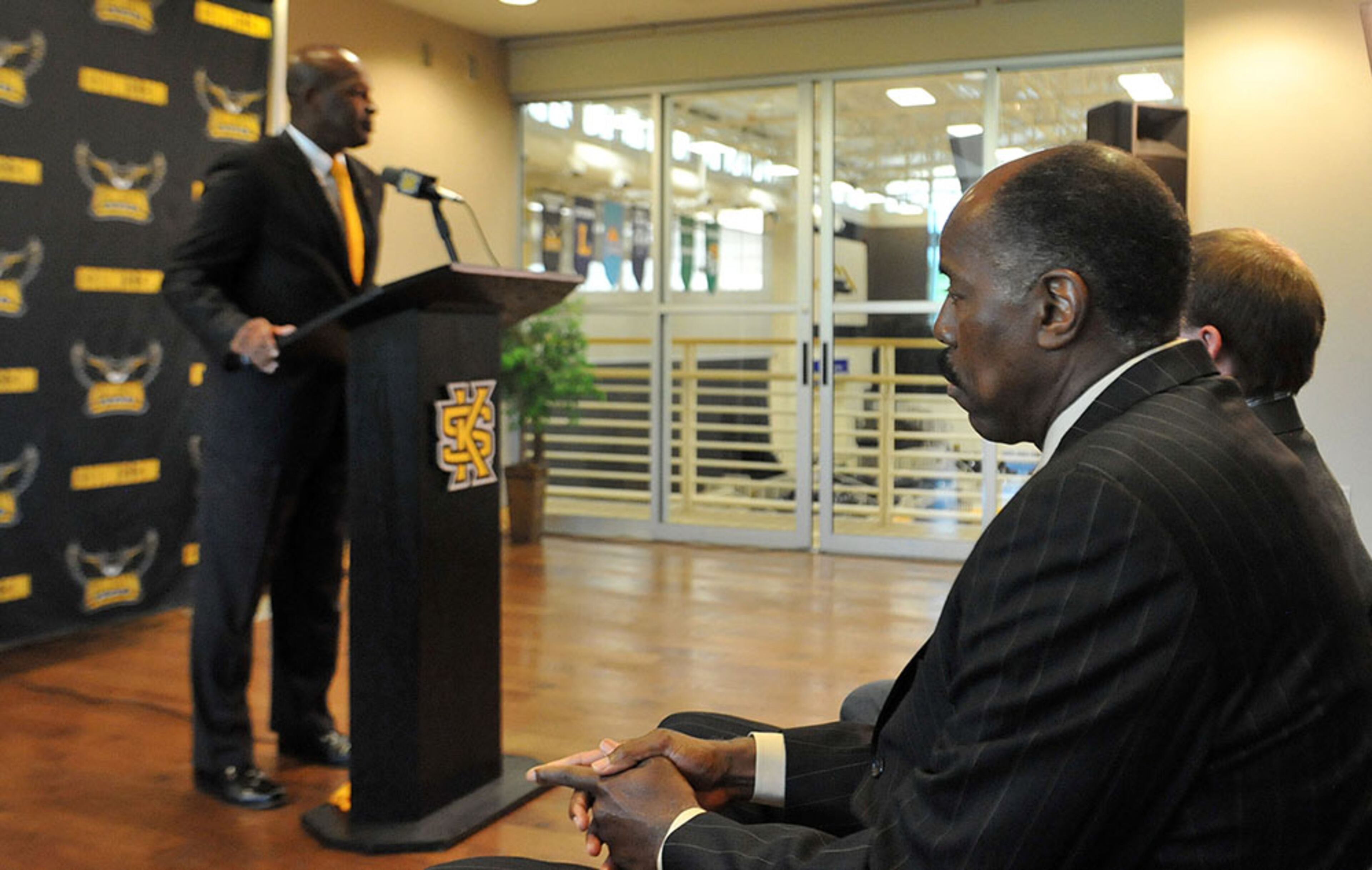 Coach Skinner listens as Athletic Director Vaughn Williams gives remarks. Kennesaw State University introduces Al Skinner as its new men's head basketball coach during a press conference Tuesday, April 28, 2015. Skinner is a former coach at Boston College.