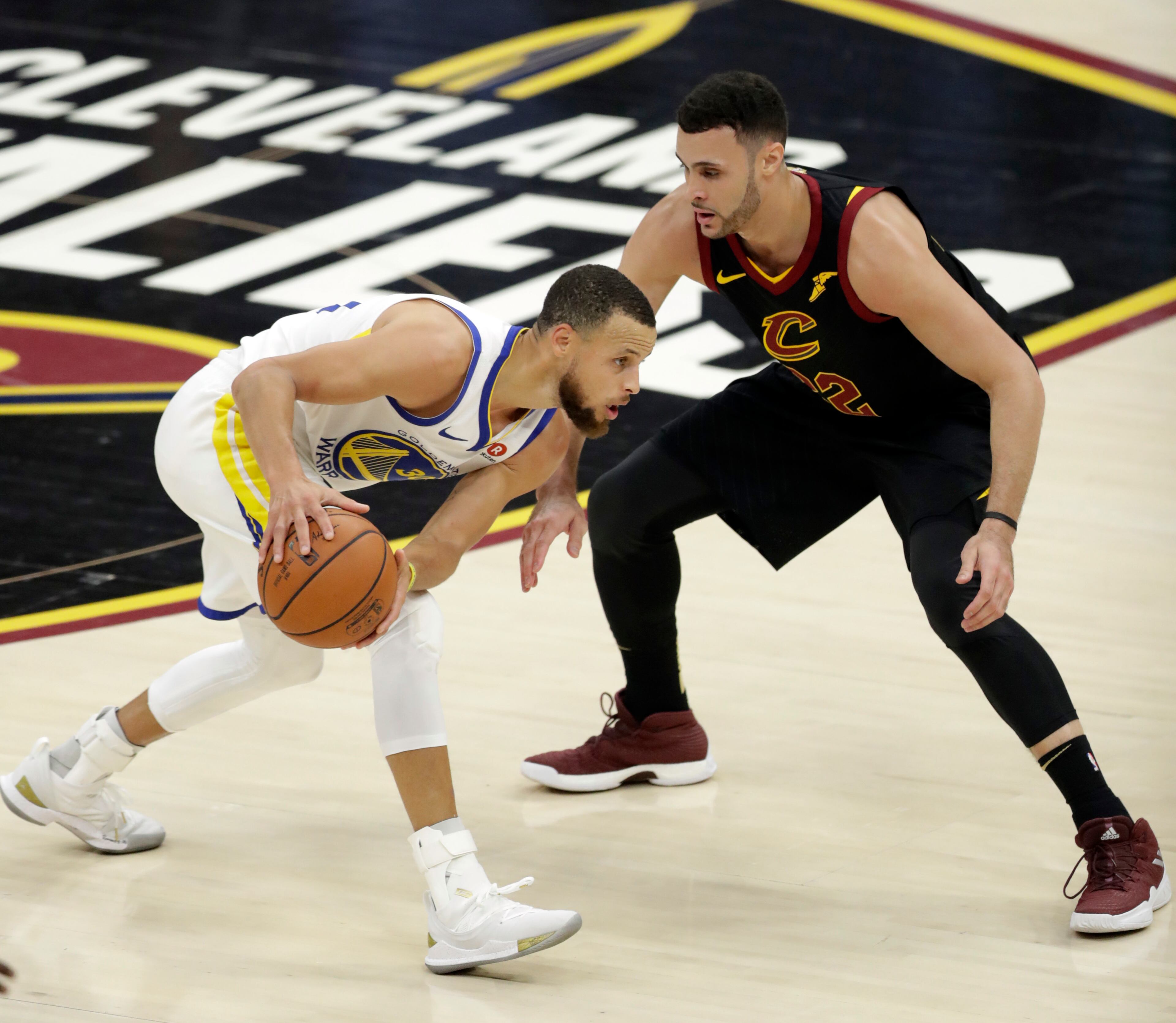 Golden State Warriors' Stephen Curry is defended by Cleveland Cavaliers' Larry Nance Jr. during the first half of Game 4 of basketball's NBA Finals, Friday, June 8, 2018, in Cleveland. (AP Photo/Tony Dejak)