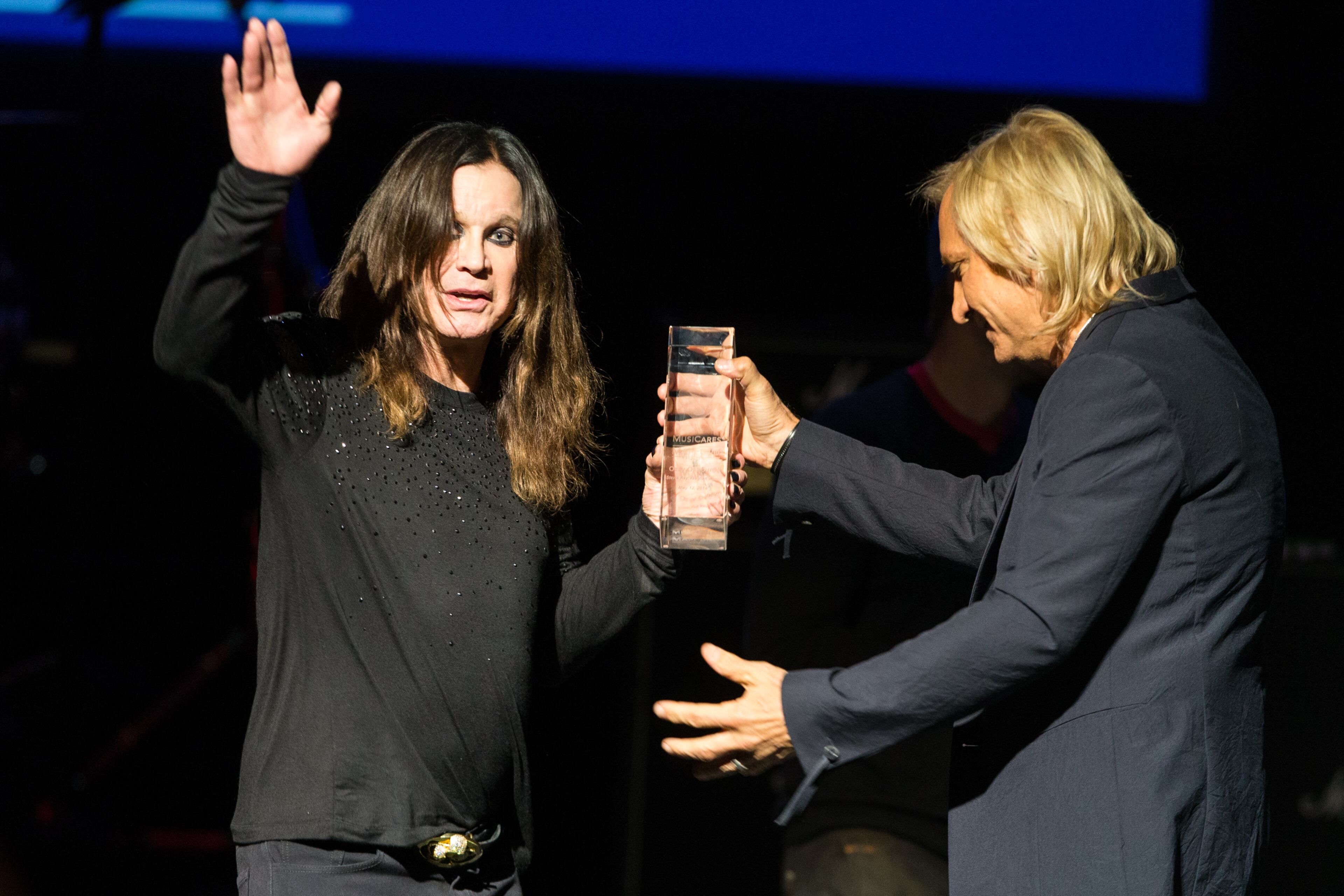 Honoree Ozzy Osbourne and Joe Walsh speak on stage at the 10th annual MusiCares MAP Fund Benefit Concert at Club Nokia on Monday, May 12, 2014 in Los Angeles. (Photo by Paul A. Hebert/Invision/AP)