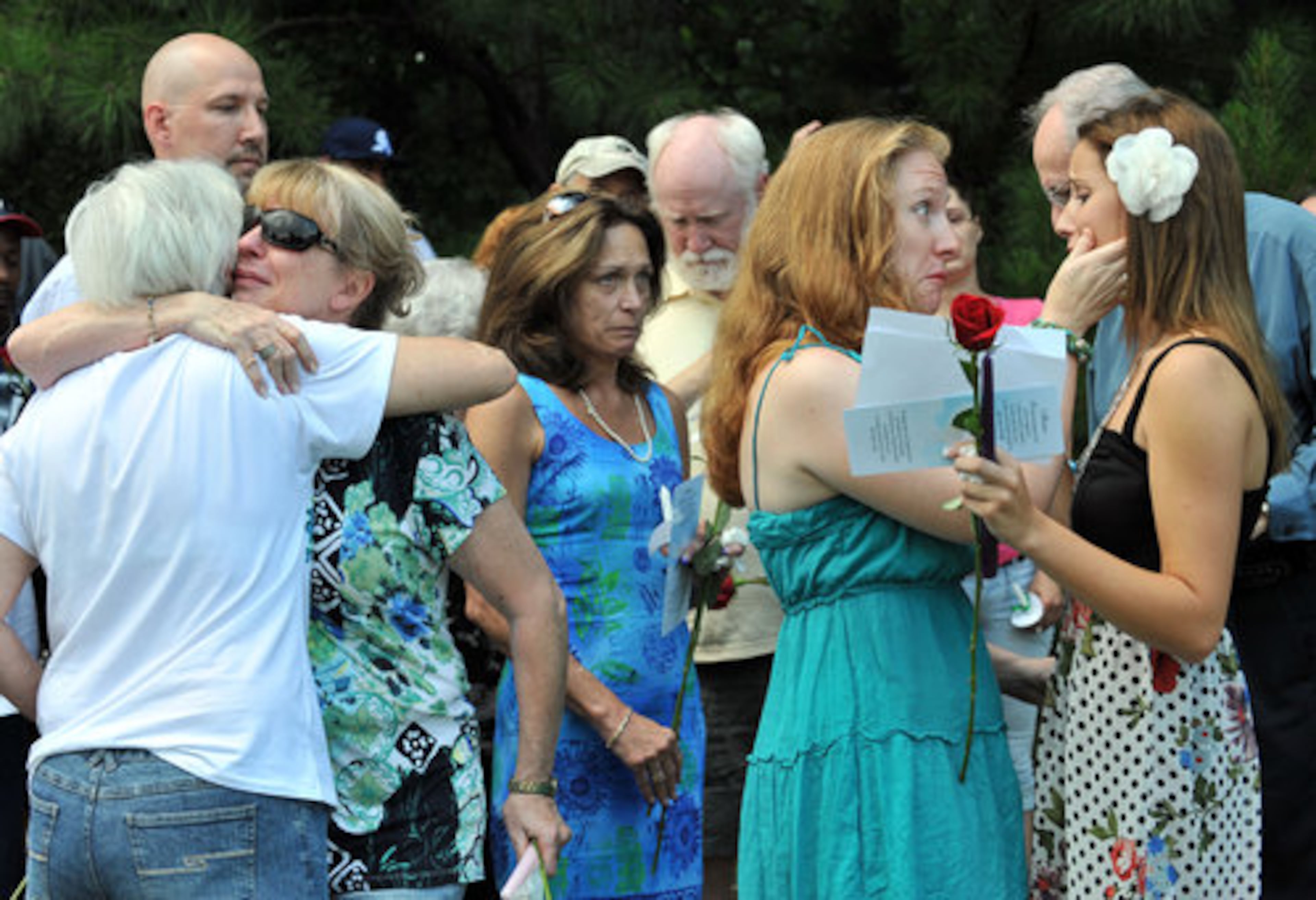 Alex Page (right), the daughter of Nique Leili, is comforted by her aunt Amy Elk.