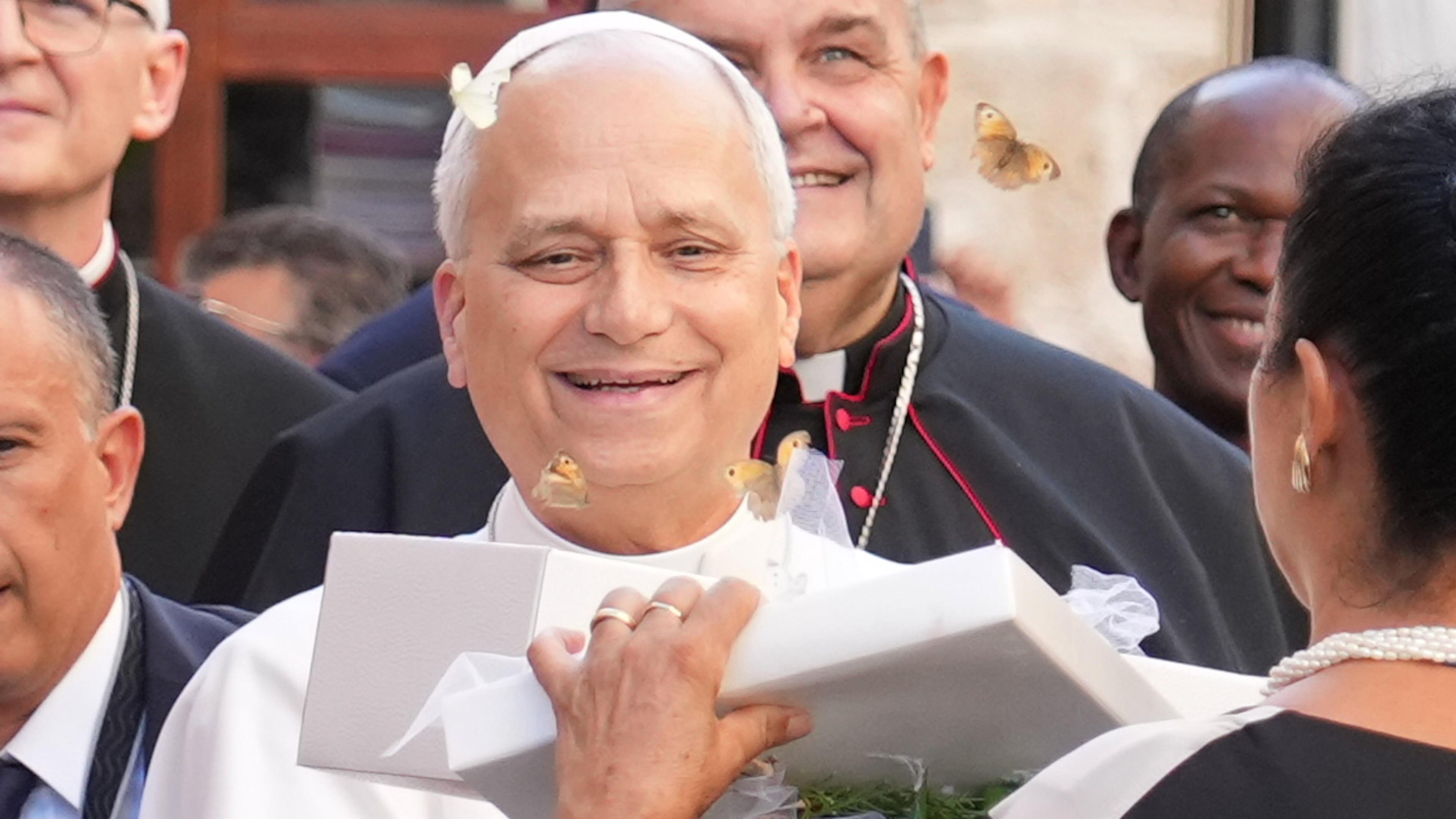 Pope Leo XIV receives a box with butterflies as he arrives at the Basilica Sanctuary of the Mother of Good Counsel in Genazzano, central Italy, Monday, Sept. 7, 2026. (AP Photo/Andrew Medichini)