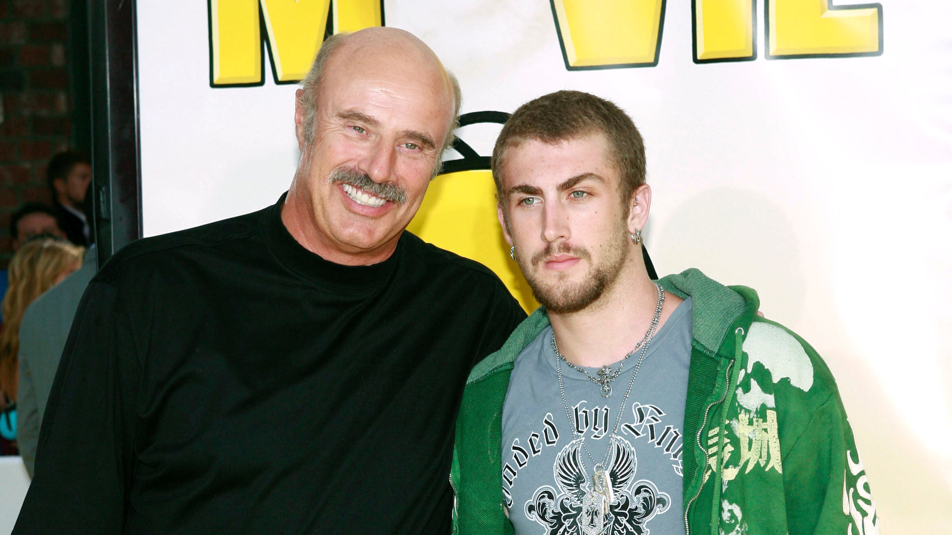 FILE - Dr. Phil McGraw, left, and his son, Jordan McGraw, arrive at the premiere of 'The Simpsons Movie' in Los Angeles, July 24, 2007. (AP Photo/Matt Sayles, File)