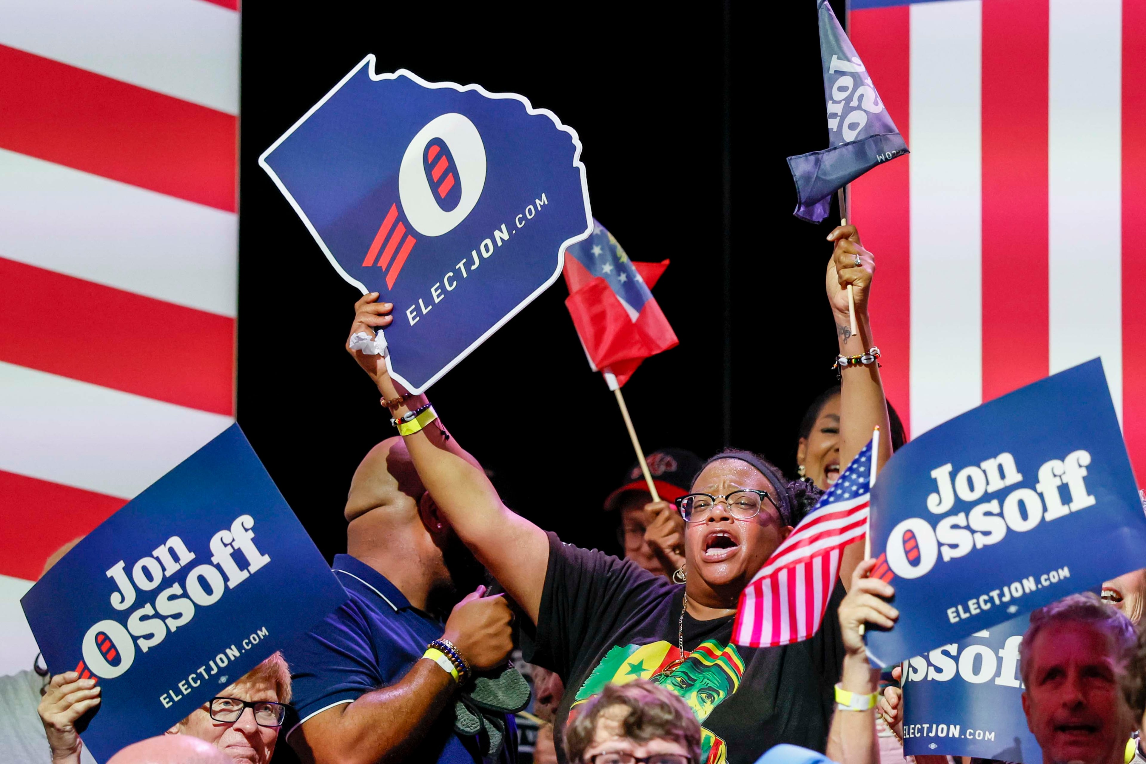 A supporter of U.S. Sen. Jon Ossoff cheers on stage ahead of the Democrat’s campaign rally in Atlanta on Sunday. (Miguel Martinez/AJC)