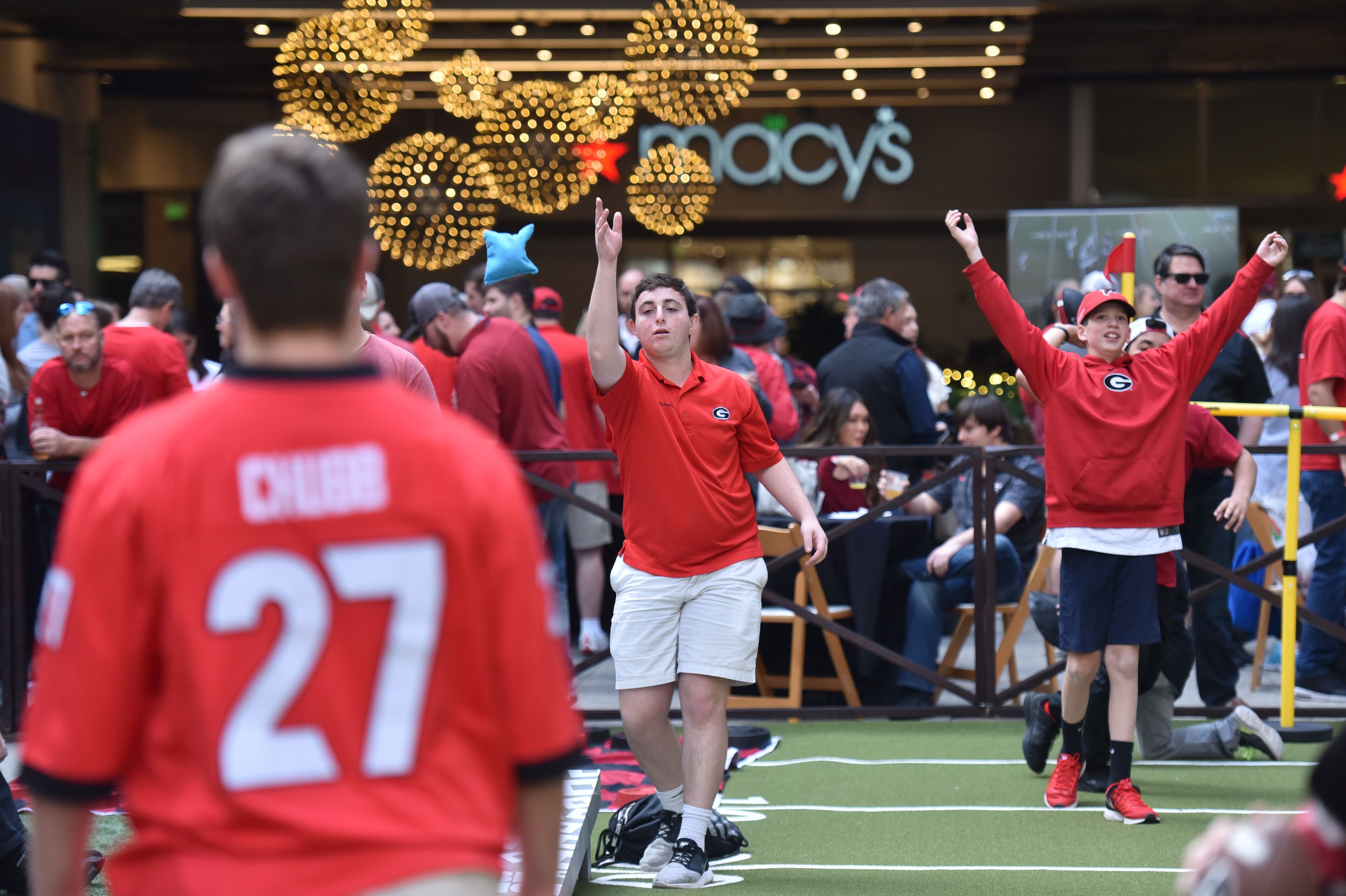December 31, 2017 Los Angeles, California - Connor Flagel (center), of Marietta, plays a game of corn hole during the Rose Bowl Bash in downtown Los Angeles on Sunday, December 31, 2017. Hyosub Shin / hshin@ajc.com