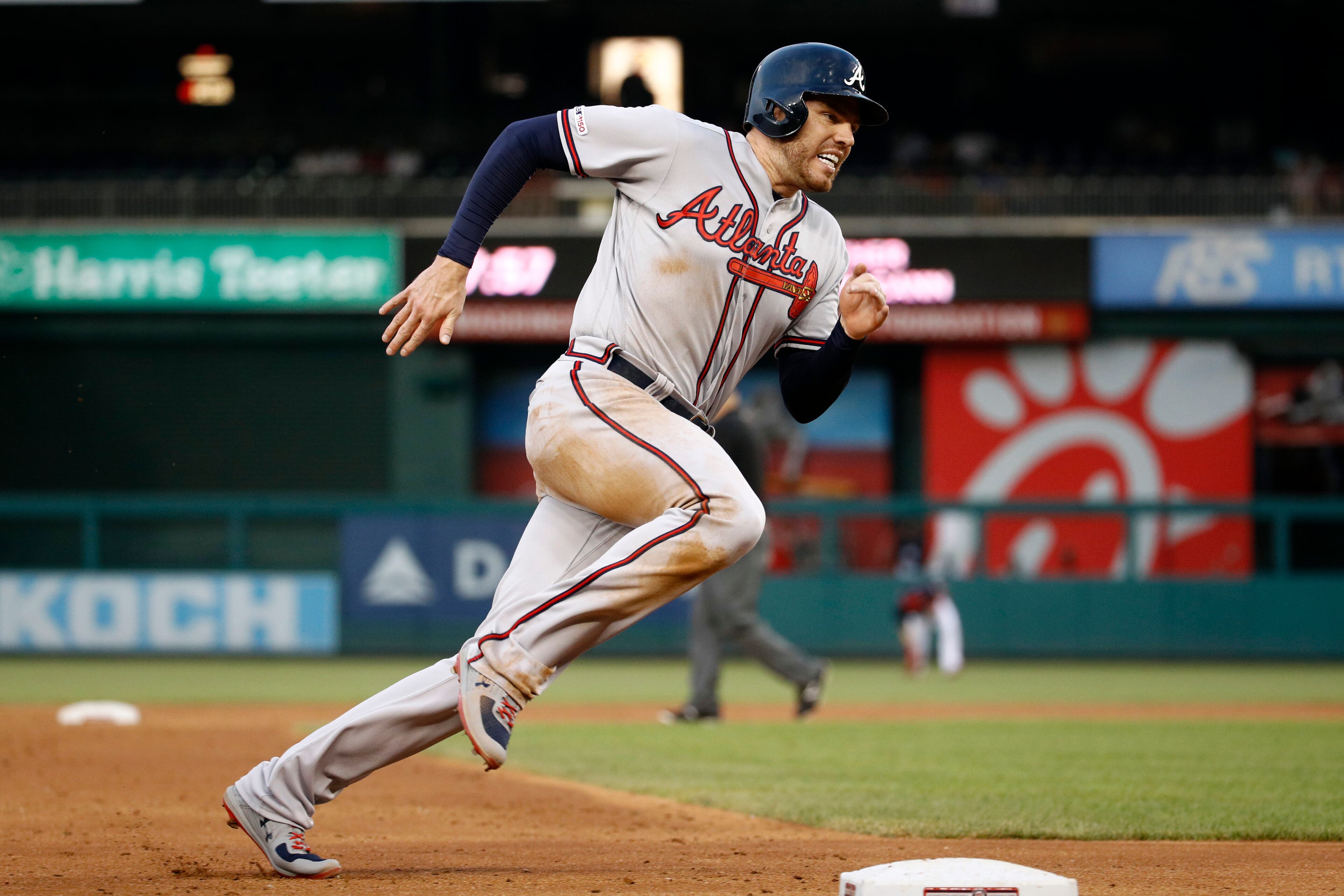 Atlanta Braves' Freddie Freeman rounds third base as he heads home to score on Brian McCann's single during the third inning of a baseball game against the Washington Nationals, Tuesday, July 30, 2019, in Washington. (AP Photo/Patrick Semansky)