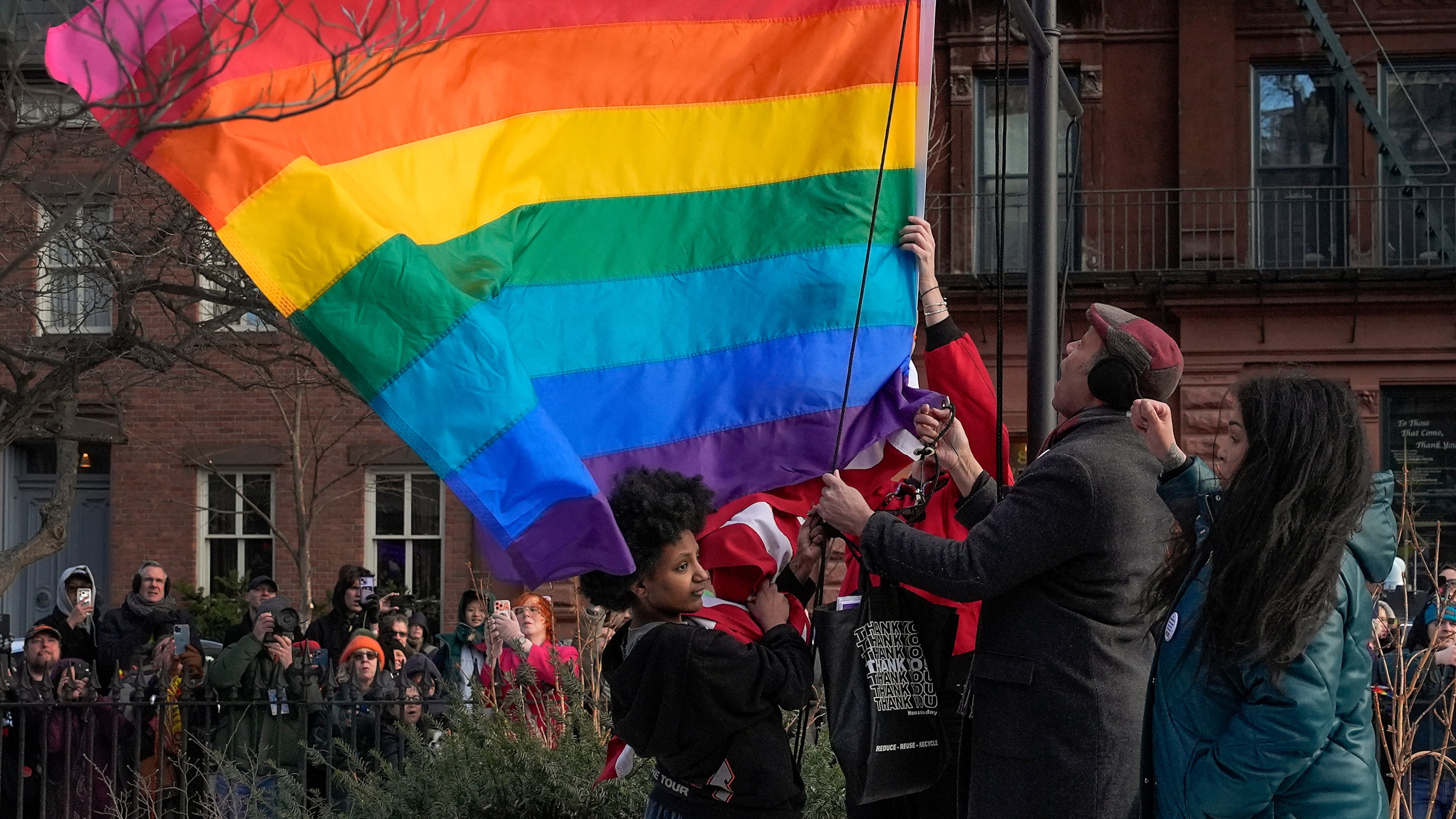 FILE - New York politicians and activists raise a rainbow flag on a pole in Christopher Park across the street from the Stonewall Inn, Thursday, Feb. 12, 2026, in New York, a few days after it was removed by the National Park Service to comply with guidance from the Trump administration. (AP Photo/Yuki Iwamura, File)