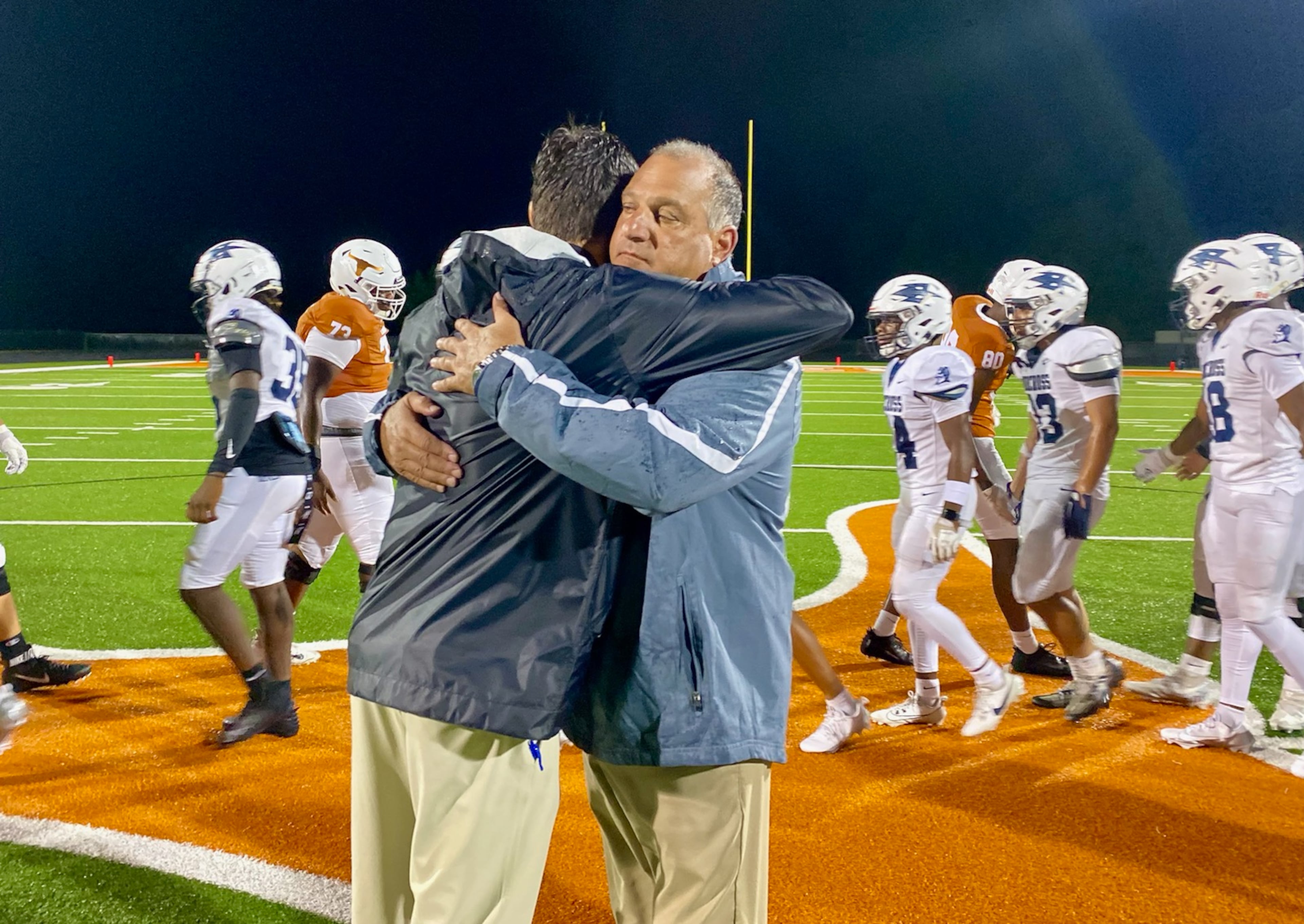 Lanier, coached by Tyler Maloof (left), and Norcross, coached by Keith Maloof, opened the 2024 season. Inclement weather and a stadium light outage extended a 31-10 Norcross win past midnight, but the Maloofs still remember the night fondly. (Ken Sugiura/AJC 2024)