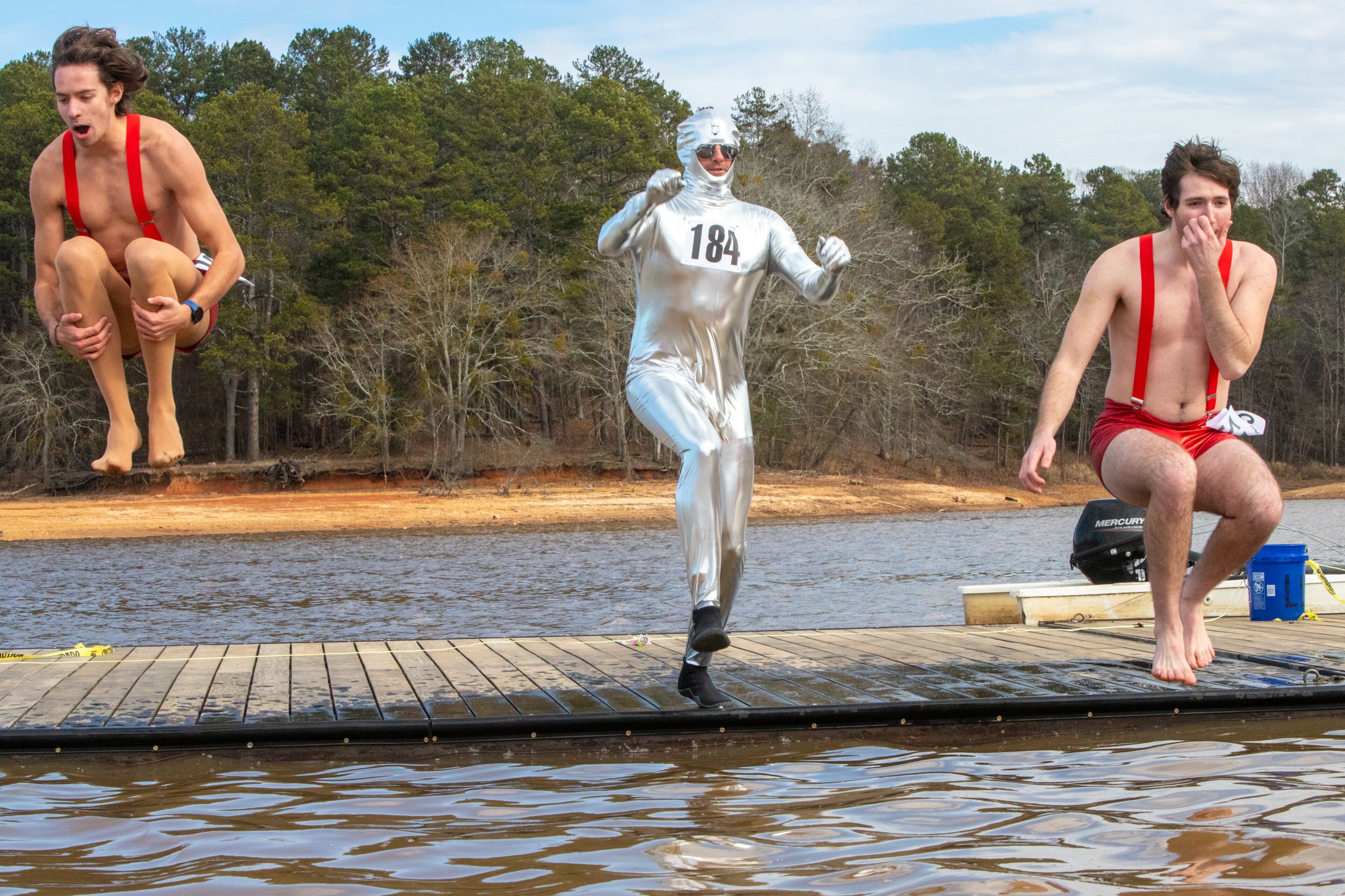 Caleb Collins, from left, John Collins and Linden Martin participate in the 26th annual Polar Bear Paddle and Plunge at Lake Lanier Olympic Park on Monday, Jan 1, 2024. There is a category of best costume in the event, as well as best splash and fastest exit from the lake. (Jenni Girtman for The Atlanta Journal-Constitution)