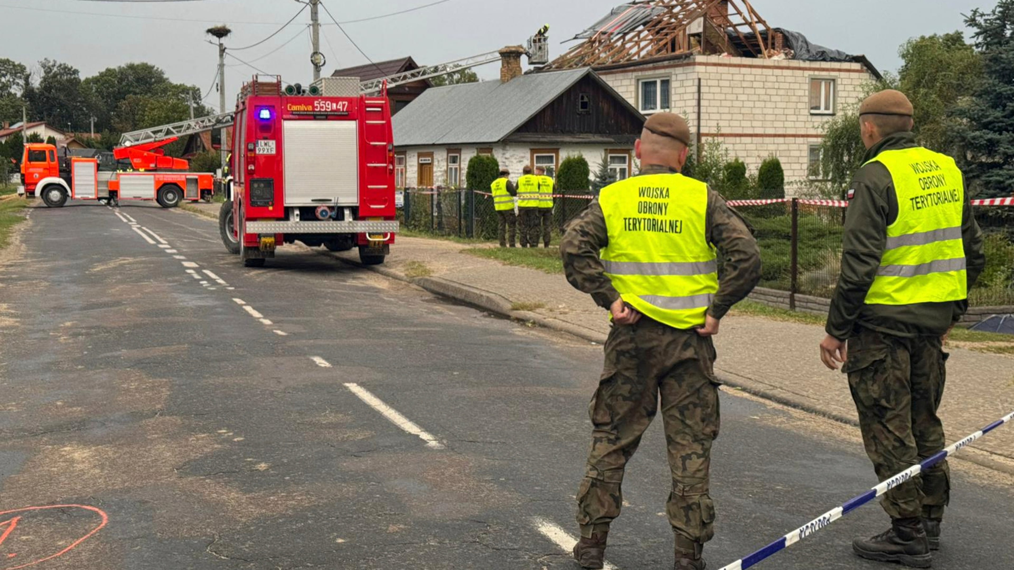 FILE - Firefighters and territorial defence officers stand close to the destroyed roof of a house, after Russian drones violated Polish airspace during an attack on Ukraine, in Wyryki near Lublin, Poland, Sept. 11, 2025. (AP Photo/Rafal Niedzielski, File)