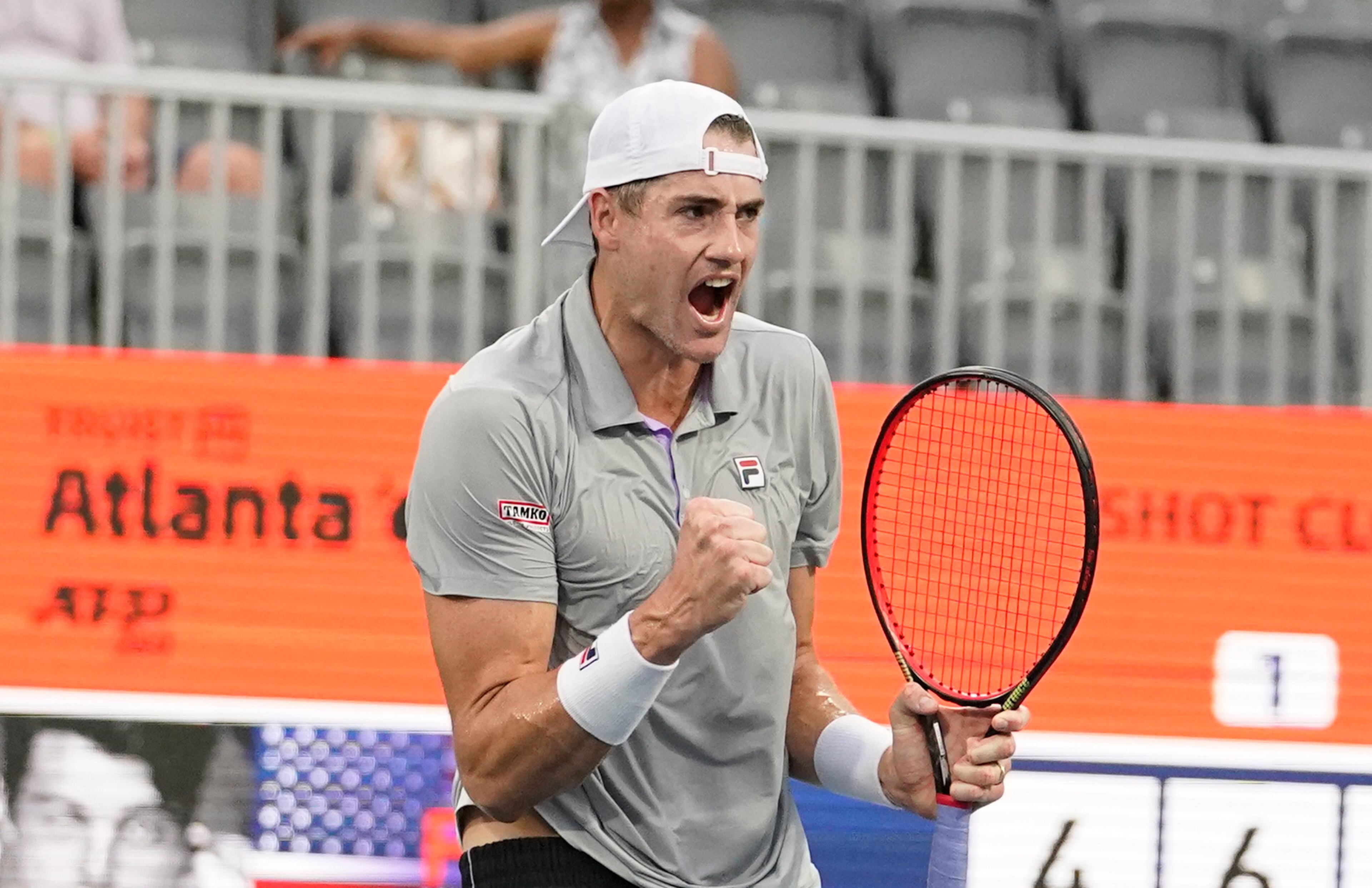 John Isner reacts after a play against Taylor Fritz during singles semifinals at the Atlanta Open Tennis tournament Saturday, July 31, 2021, in Atlanta. (AP Photo/Brynn Anderson)