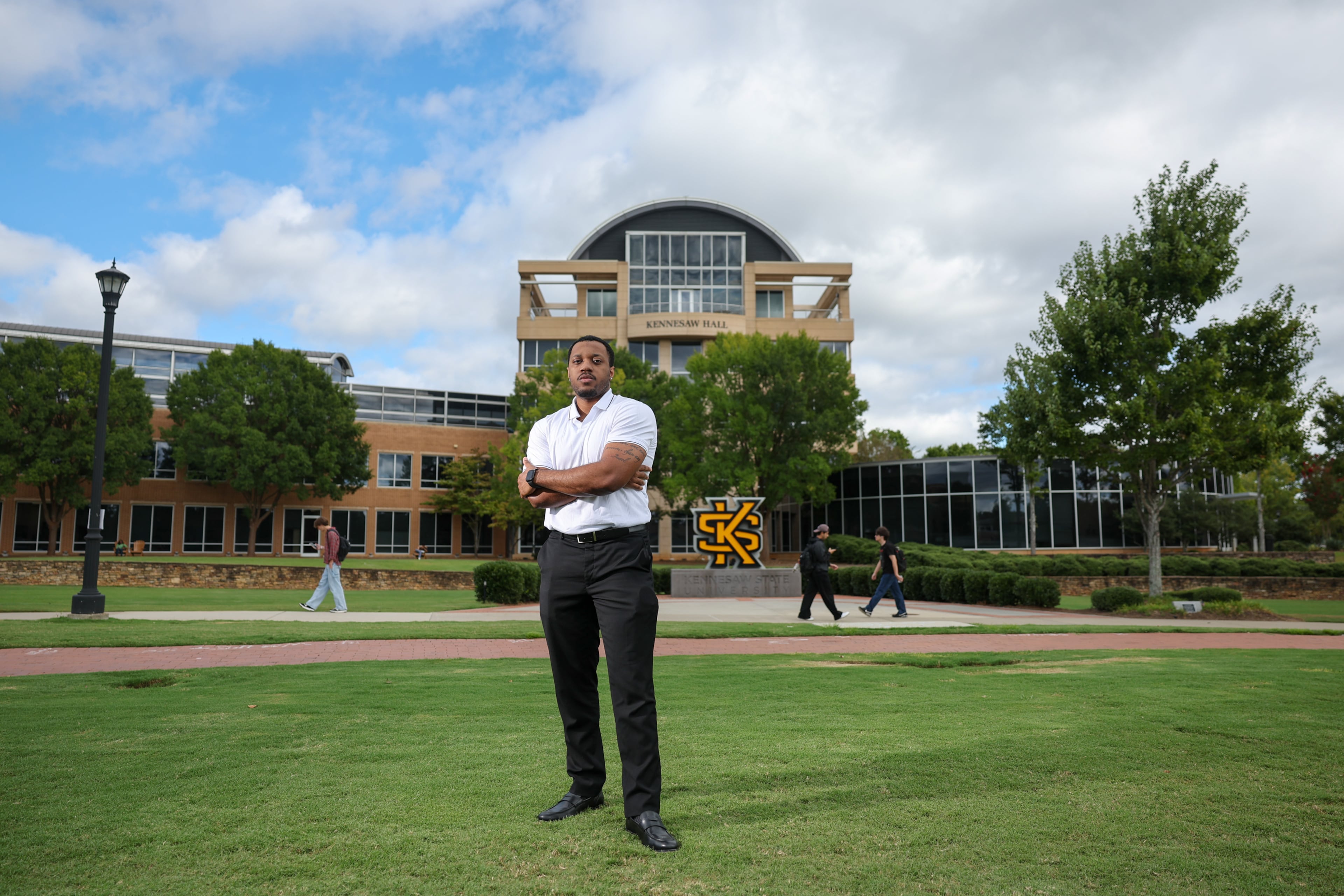 Joshua Faulk, 24, a junior at Kennesaw State University, poses for a portrait at KSU in Kennesaw last month. (Arvin Temkar/AJC)