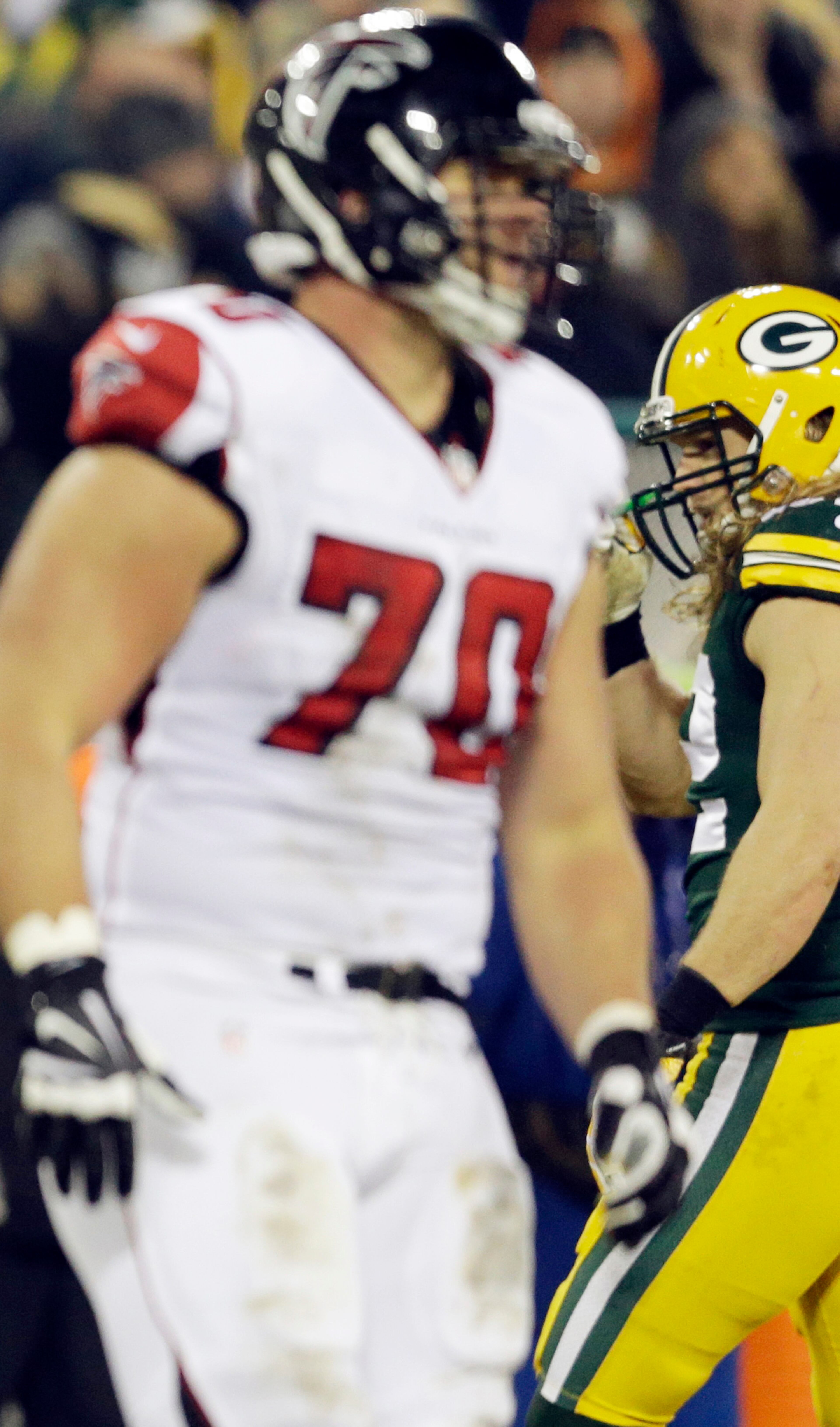Atlanta Falcons' Jake Matthews (70) and cousin Green Bay Packers' Clay Matthews cross paths during the first half Monday, Dec. 8, 2014, in Green Bay, Wis.