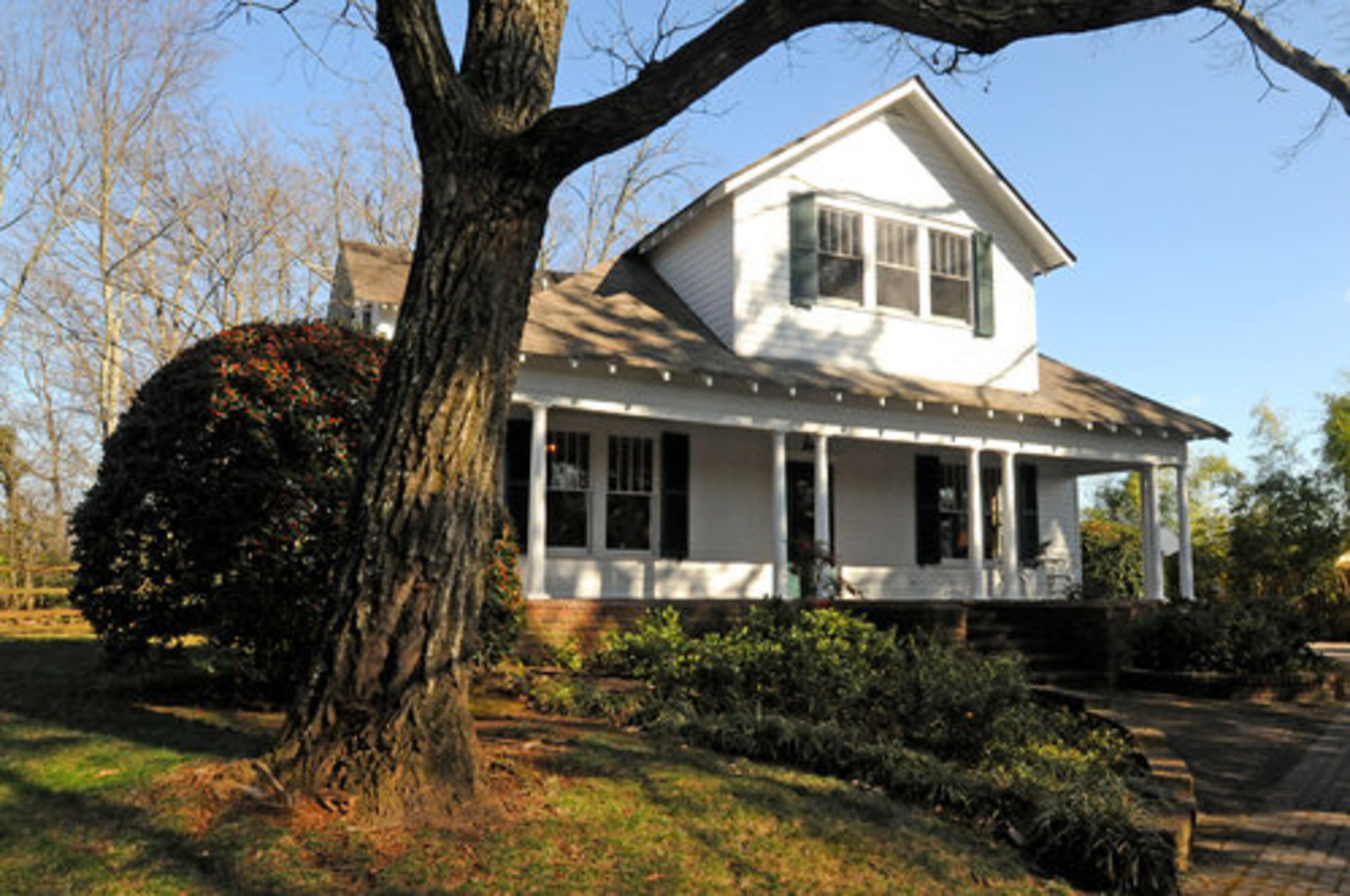 Exterior of the Mitchell House in Sandy Springs. The Godlewski's home is surrounded by trees, both in the front and rear of the property. The home has been recognized by the Sandy Springs Historical Society as one of the oldest buildings in the area.