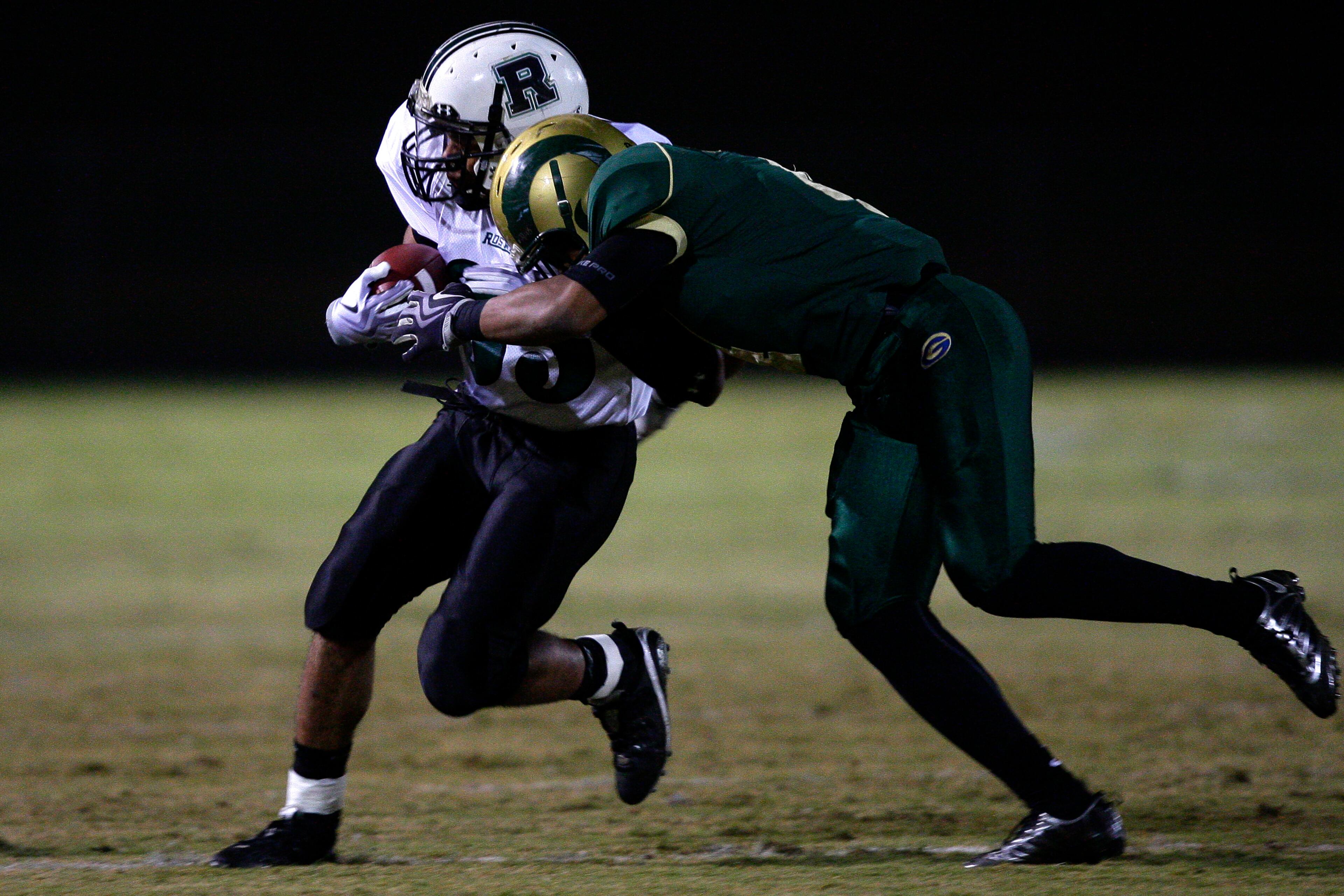 Roswell High School's Duvall Smith (35) gets hit by Grayson High School's Denzel Nkemdiche (4).