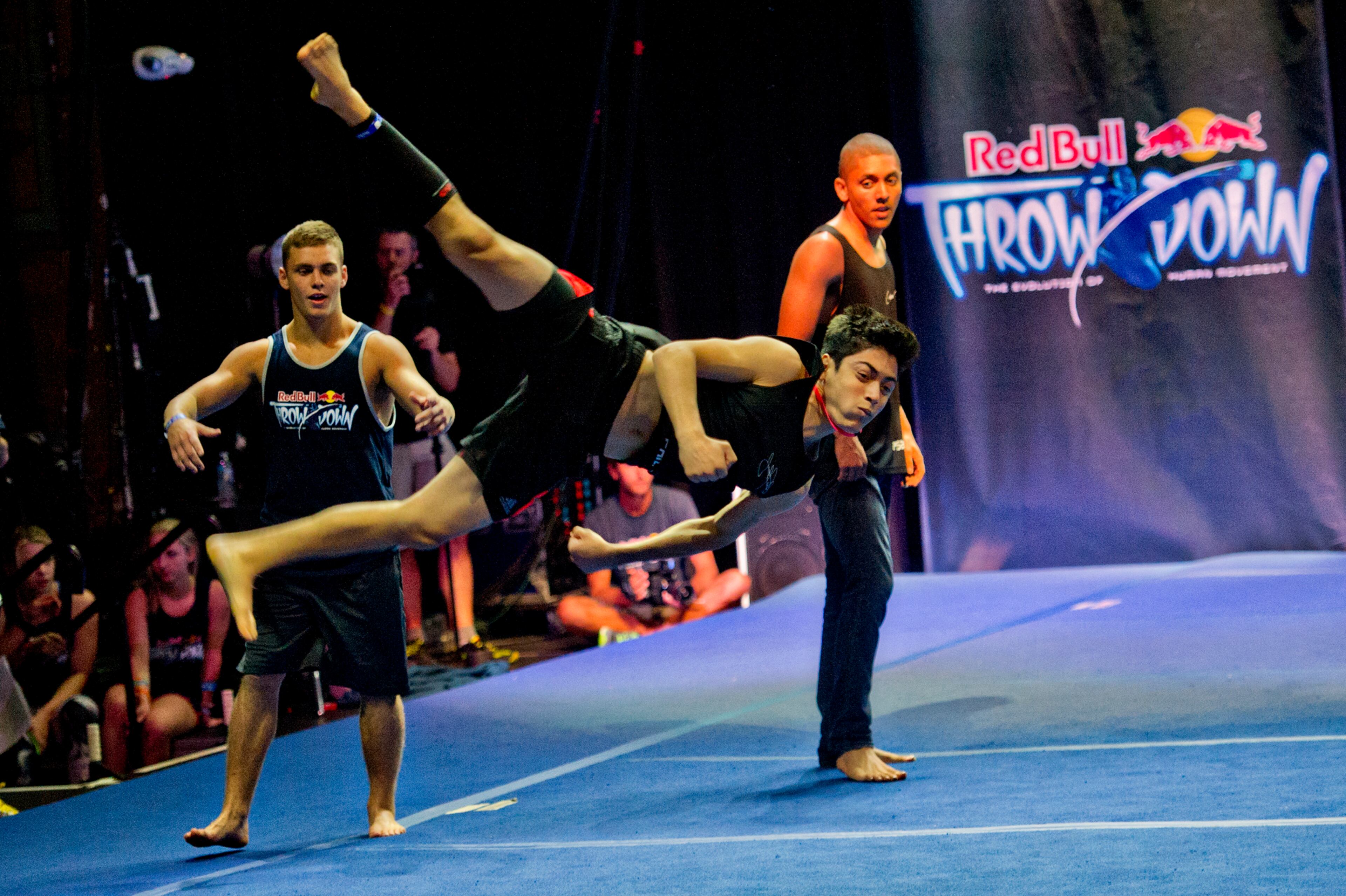 Jacob Pinto (center) flies through the air while teammates Bailey Payne (left) and Donovan Sheehan (right) watch during the Red Bull Throwdown Atlanta at the Tabernacle in Atlanta on Sunday, Sept. 28, 2014. Sixteen of the top international trickers competed.Tricking is a new sport that combines martial arts, tumbling and break dancing, kicking and flipping. JONATHAN PHILLIPS / SPECIAL