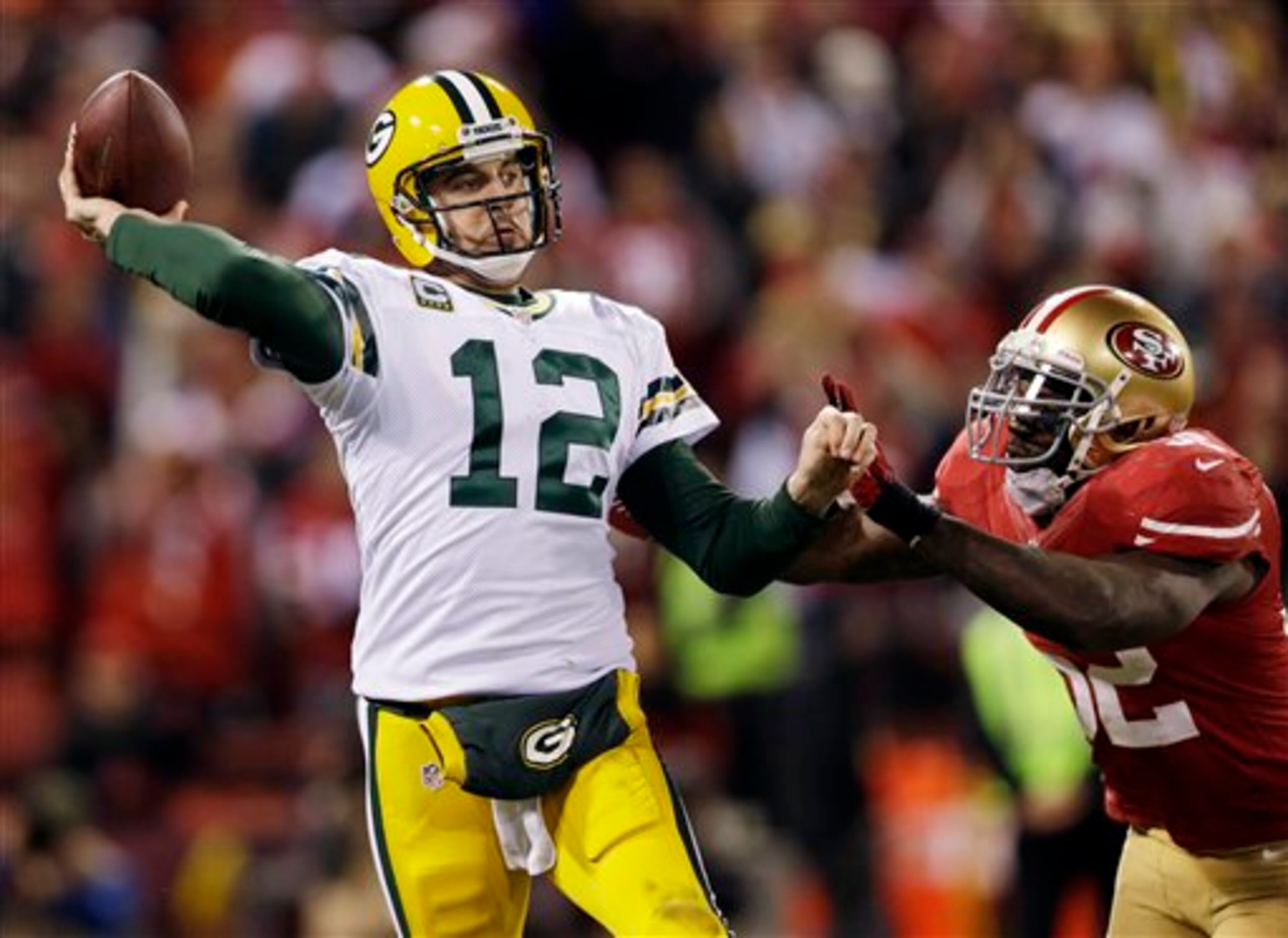 Green Bay Packers quarterback Aaron Rodgers (12) is pressured by San Francisco 49ers linebacker Patrick Willis (52) during the third quarter of an NFC divisional playoff NFL football game in San Francisco, Saturday, Jan. 12, 2013. (AP Photo/Marcio Jose Sanchez)