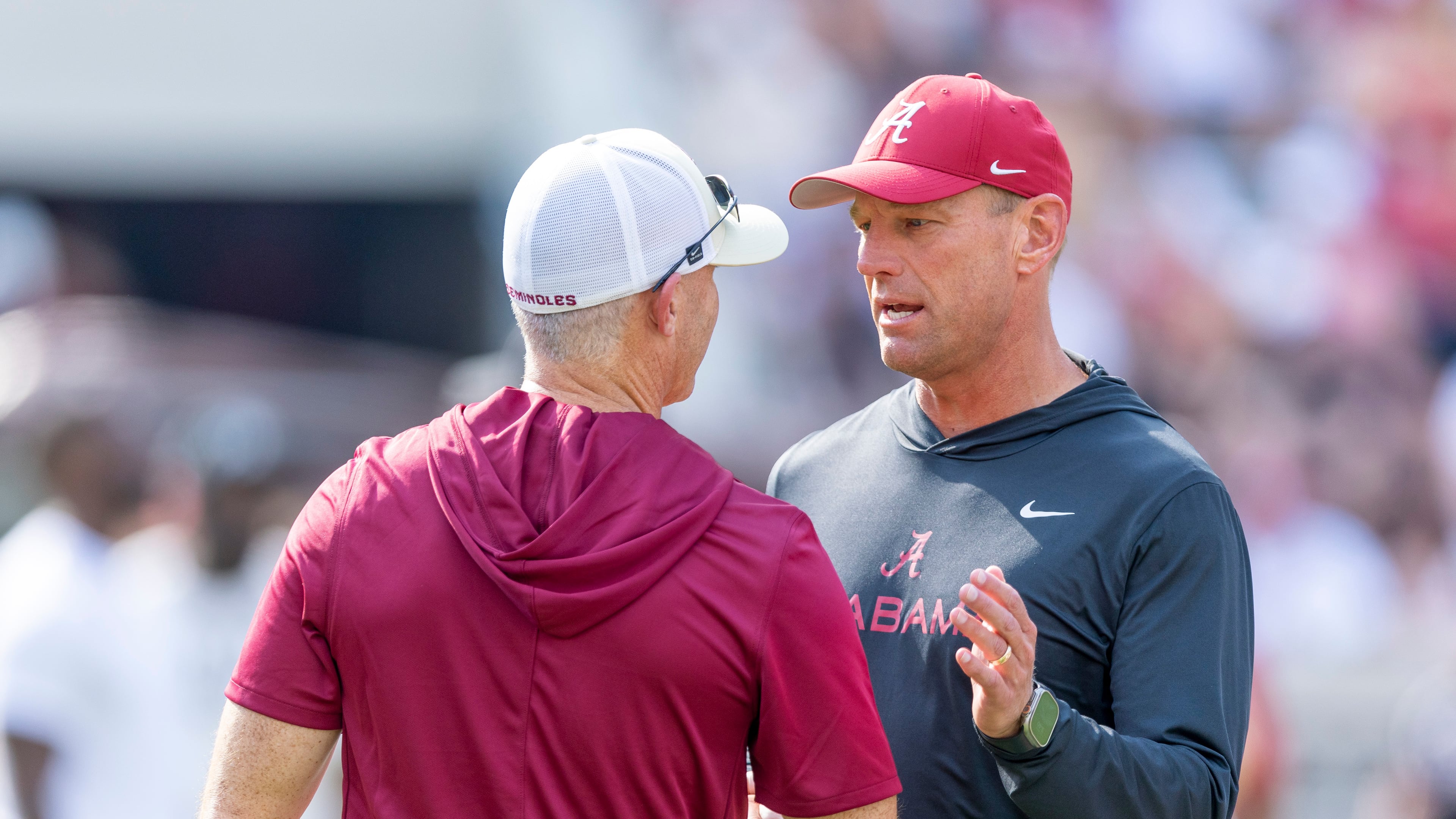 Alabama head coach Kalen DeBoer, right, meets with Florida State head coach Mike Norvell, left, before an NCAA college football game Saturday, Sept. 19, 2026, in Tuscaloosa, Ala. (AP Photo/Vasha Hunt)