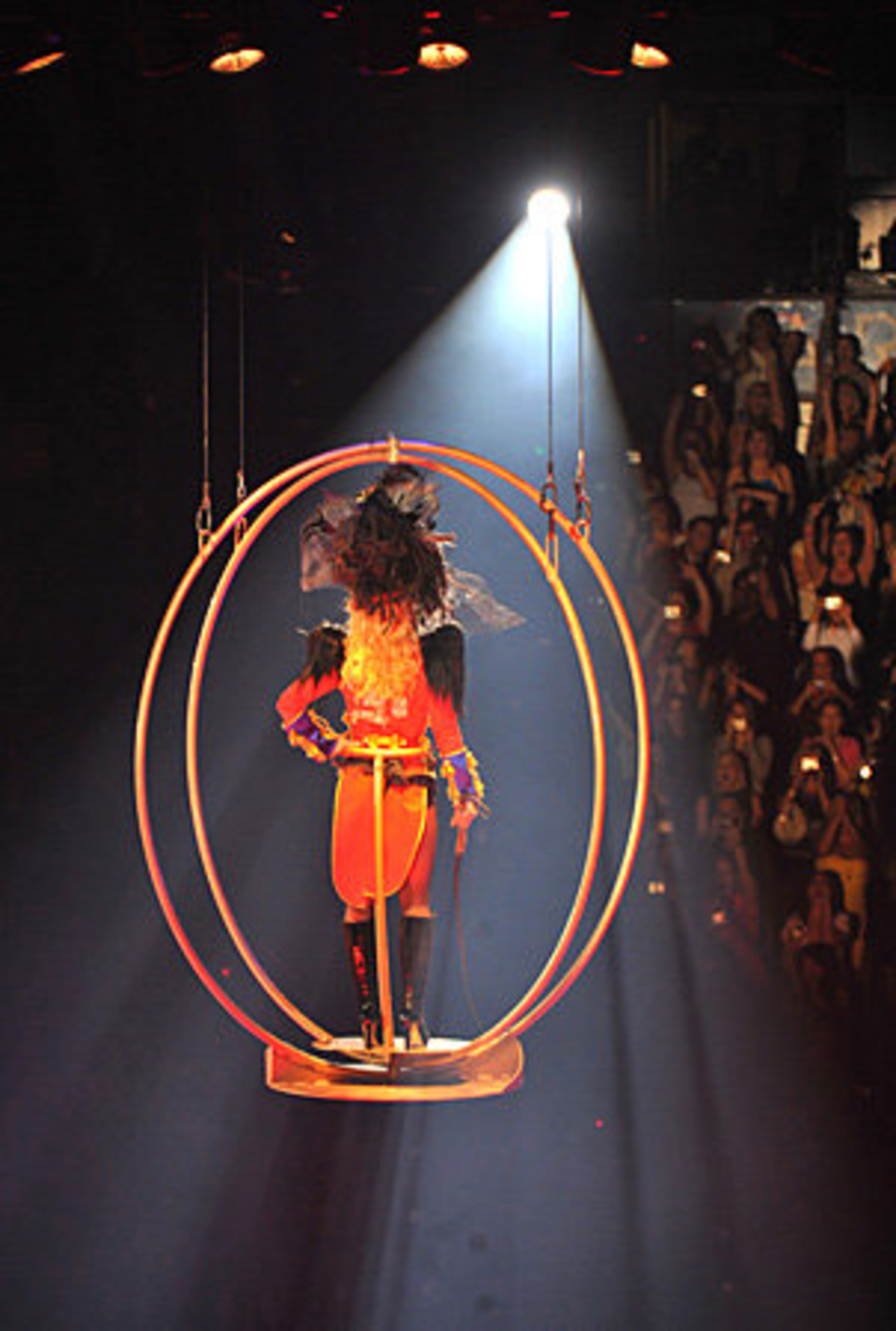 Britney Spears descends from the ceiling to greet the excited crowd. Dressed as a ringmaster, Britney is sending a message that she has her sideshow of a personal life under control.
