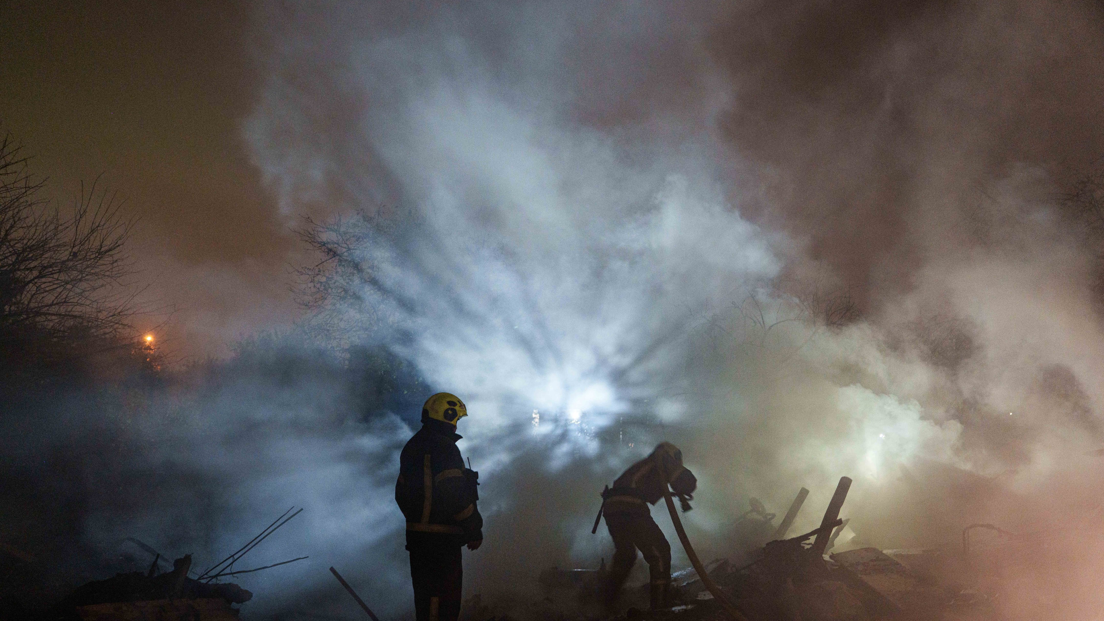 Rescue workers put out a fire at a residential house destroyed in a Russian missile strike on Kyiv, Ukraine, Wednesday, Oct. 21, 2026. (AP Photo/Evgeniy Maloletka)