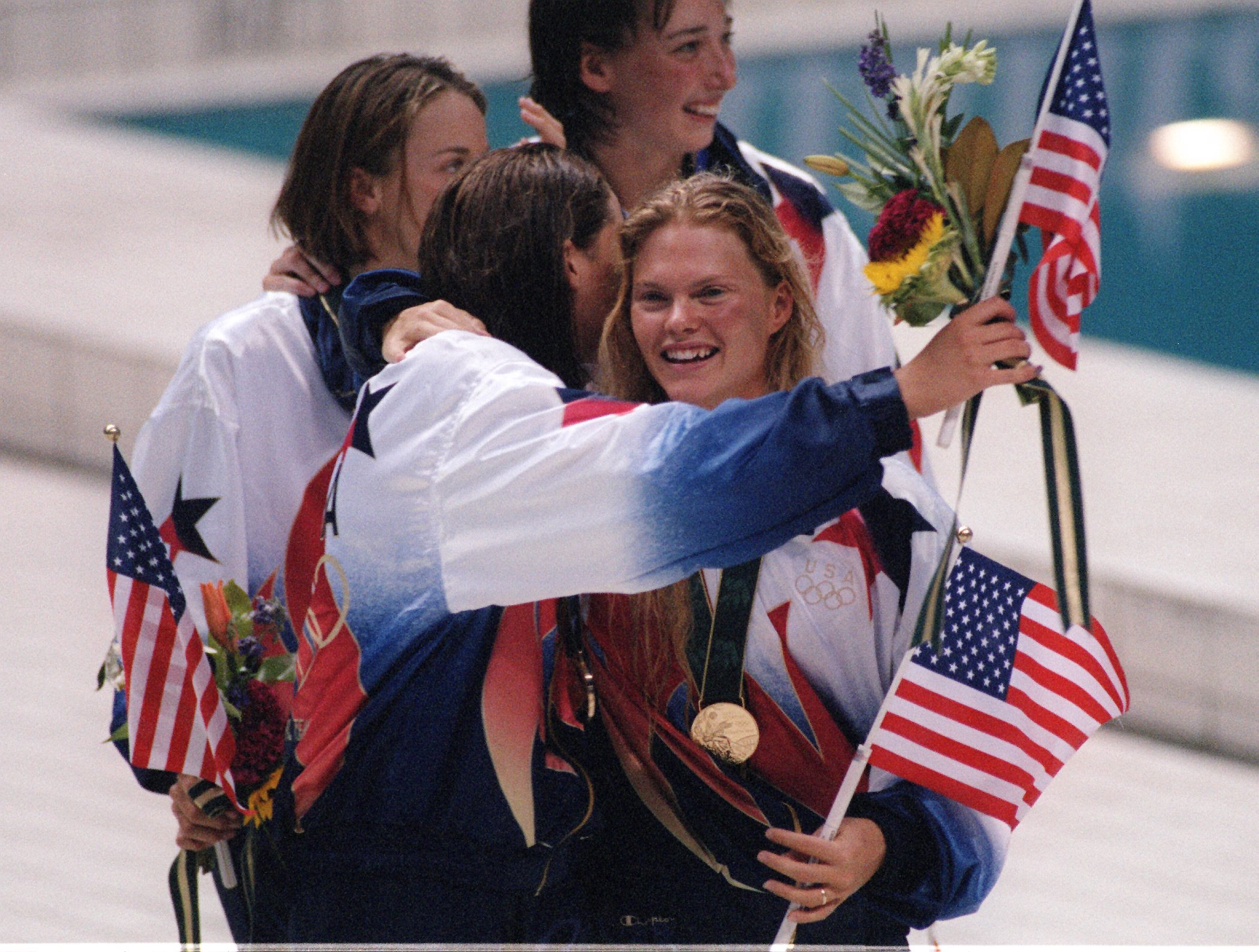 Angel Martino smiles with her teammates after getting the gold in the 400 meter medley. (AJC Staff Photo/Jonathan Newton)