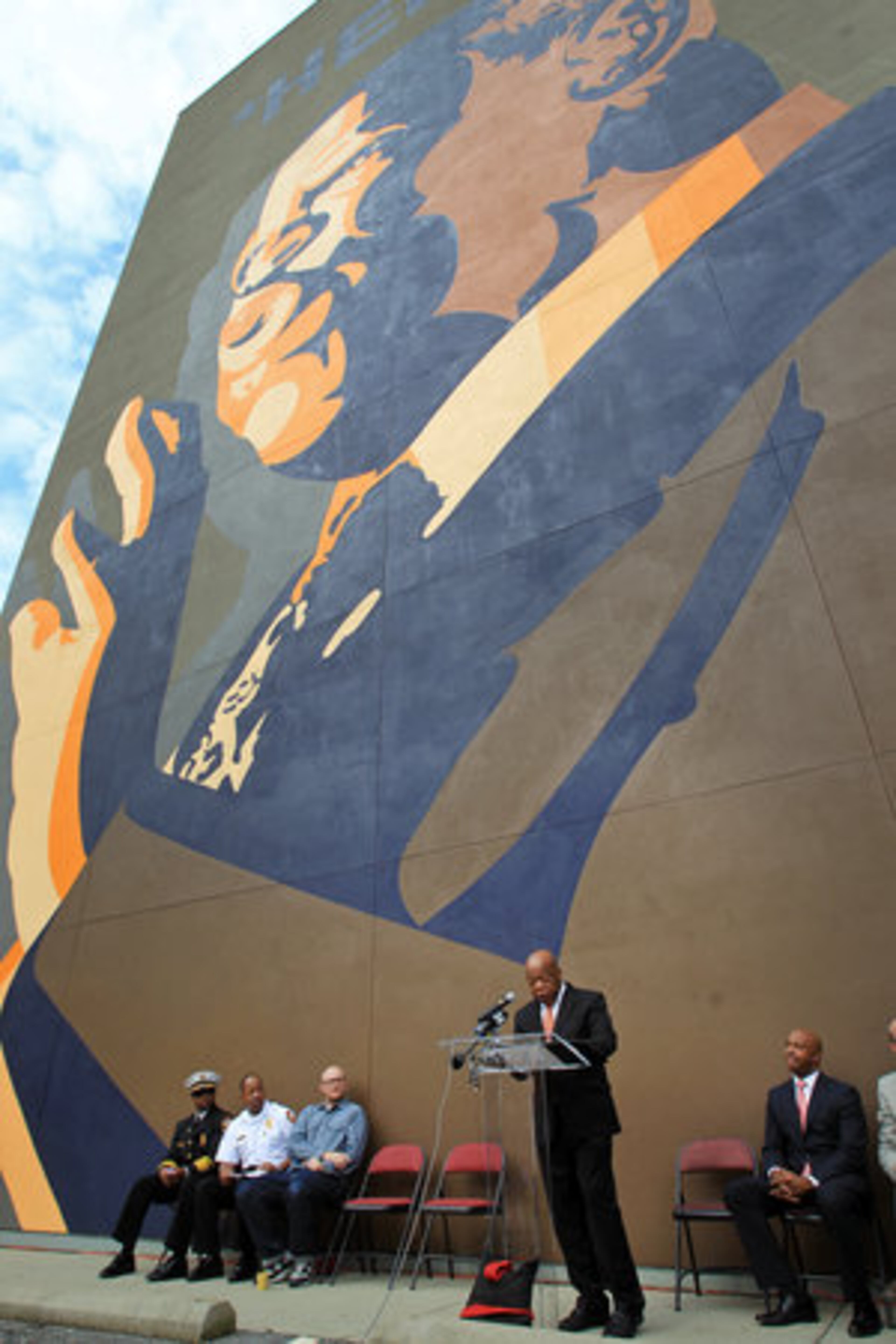 Lewis speaks Friday in front of the mural.