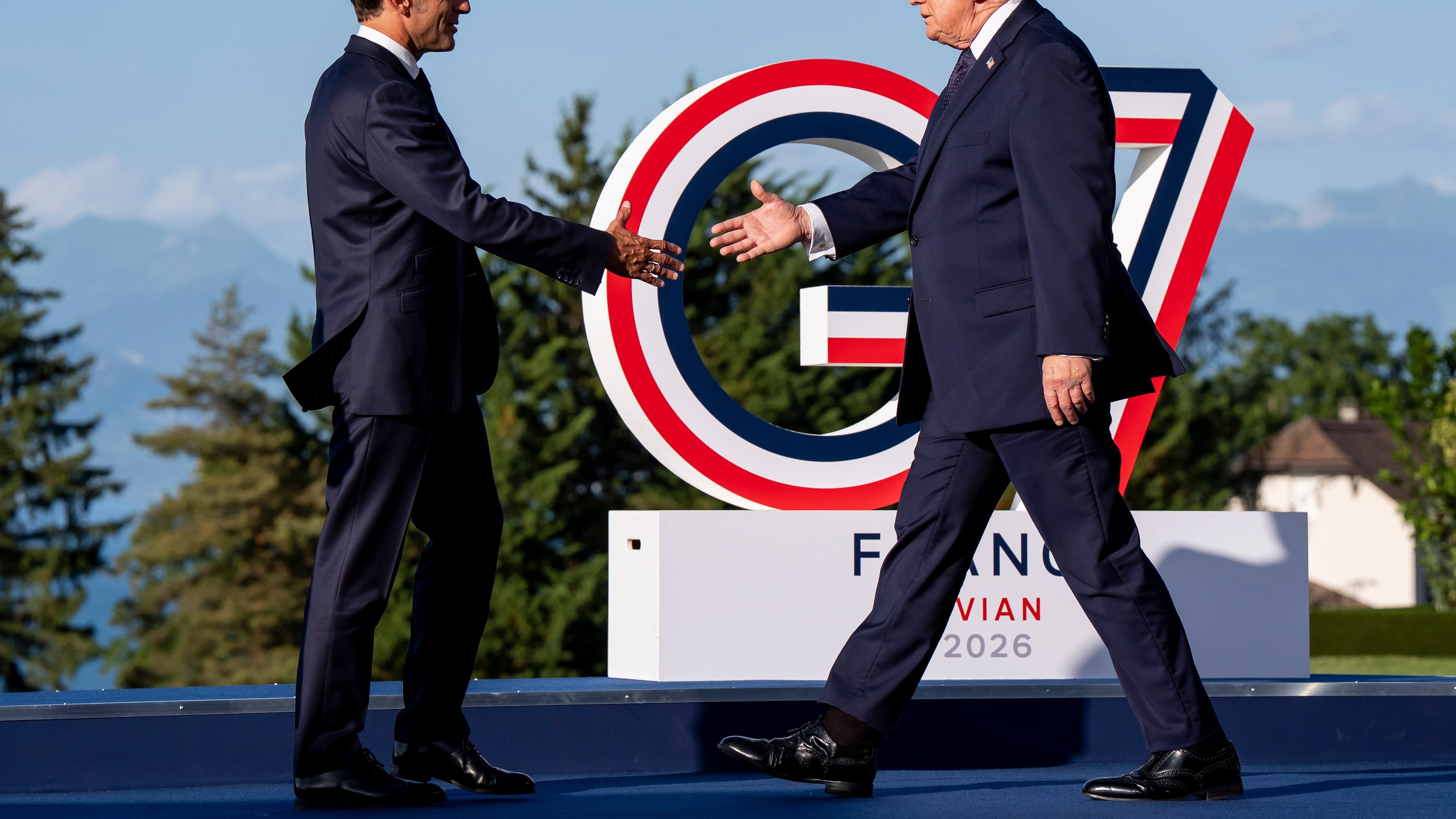 Emmanuel Macron, President of France, left, greets U.S. President Donald Trump during the G7 summit in Evian-les-Bains, France, Monday, June 15, 2026. (Christopher Katsarov/The Canadian Press via AP)