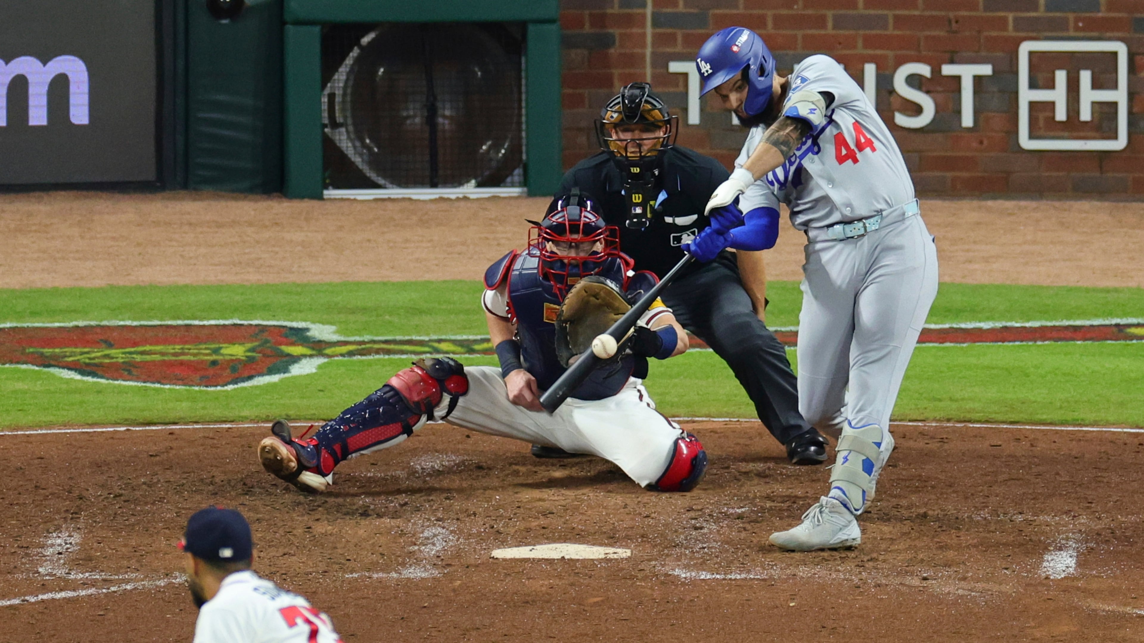Los Angeles Dodgers center fielder Andy Pages (44) hits a two run RBI-single off a pitch by Atlanta Braves pitcher Didier Fuentes, bottom left, during the seventh inning in Game 4 of baseball's National League Division Series, Wednesday, Oct. 7, 2026, in Atlanta. (AP Photo/Colin Hubbard)