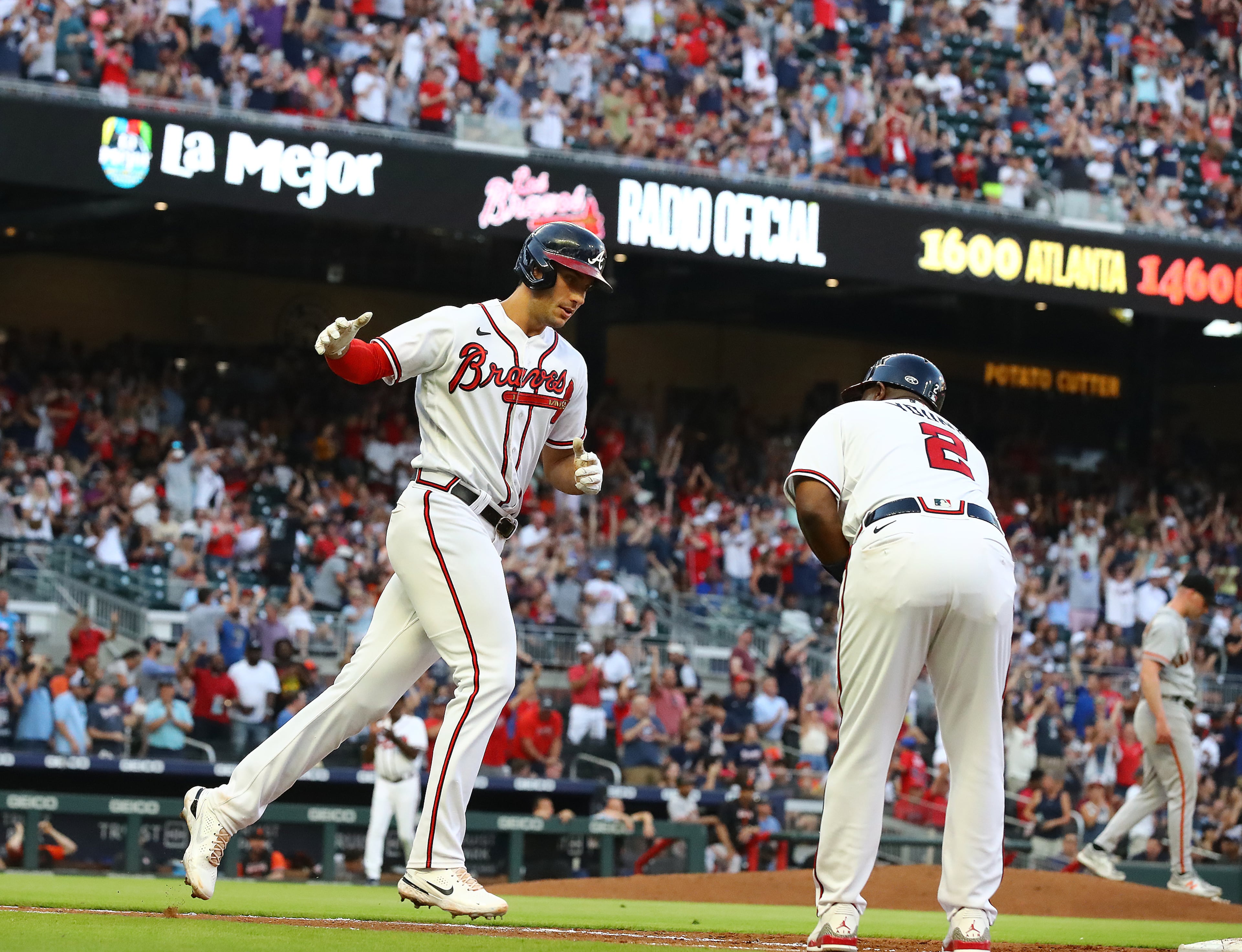 Braves first baseman Matt Olson gets five from first base coach Eric Young after hitting a 3-run homer to take a 5-4 lead over the San Francisco Giants during the third inning of a MLB baseball game on Tuesday, June 21, 2022, in Atlanta. “Curtis Compton / Curtis.Compton@ajc.com”