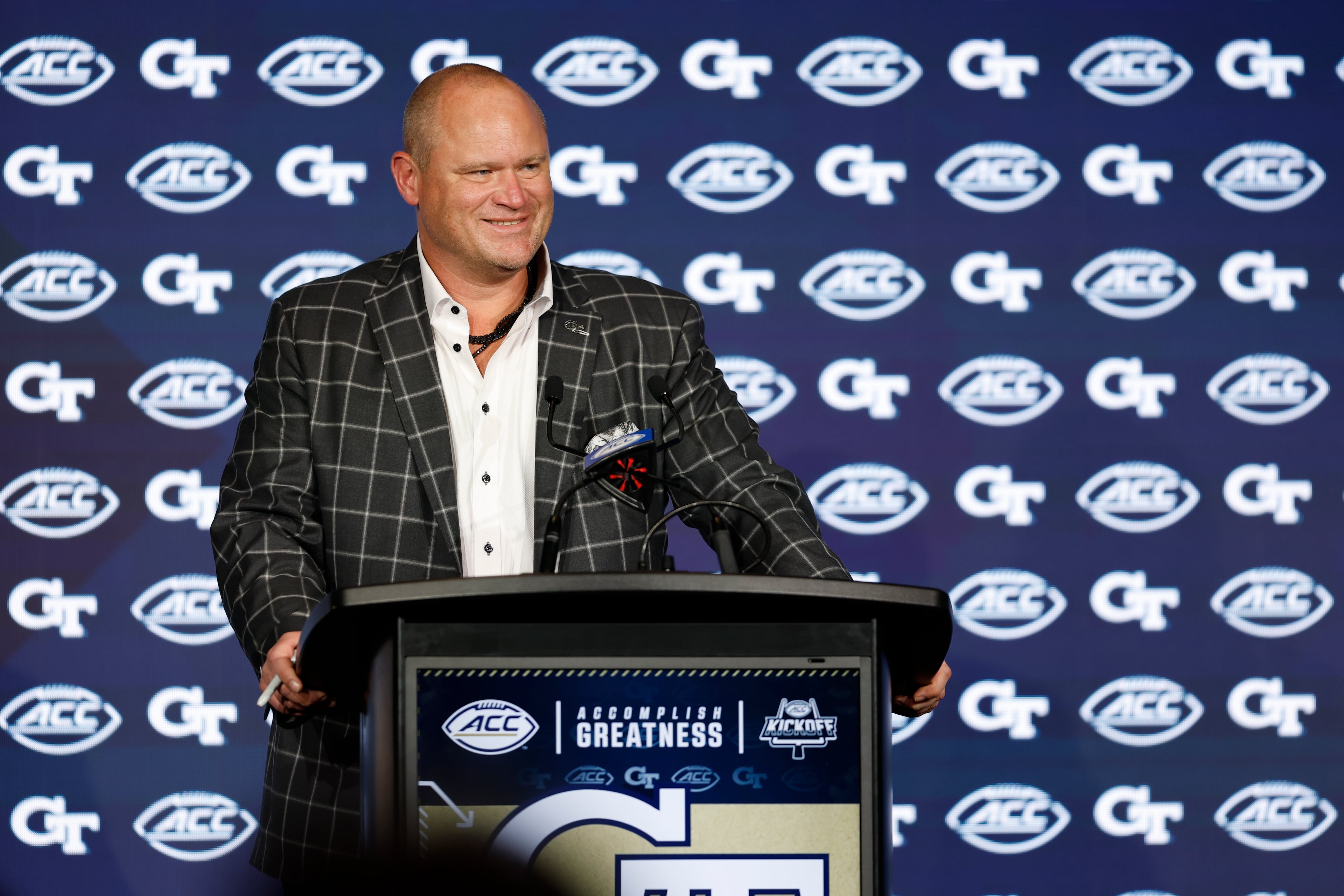 Earlier this summer, Tech coach Brent Key, shown speaking to the media Wednesday, July 23, 2025, at the ACC Football Kickoff, relayed how Keylan Rutledge has taken the Yellow Jackets offense — and much of the team for that matter — by the horns. (Nell Redmond/ACC)