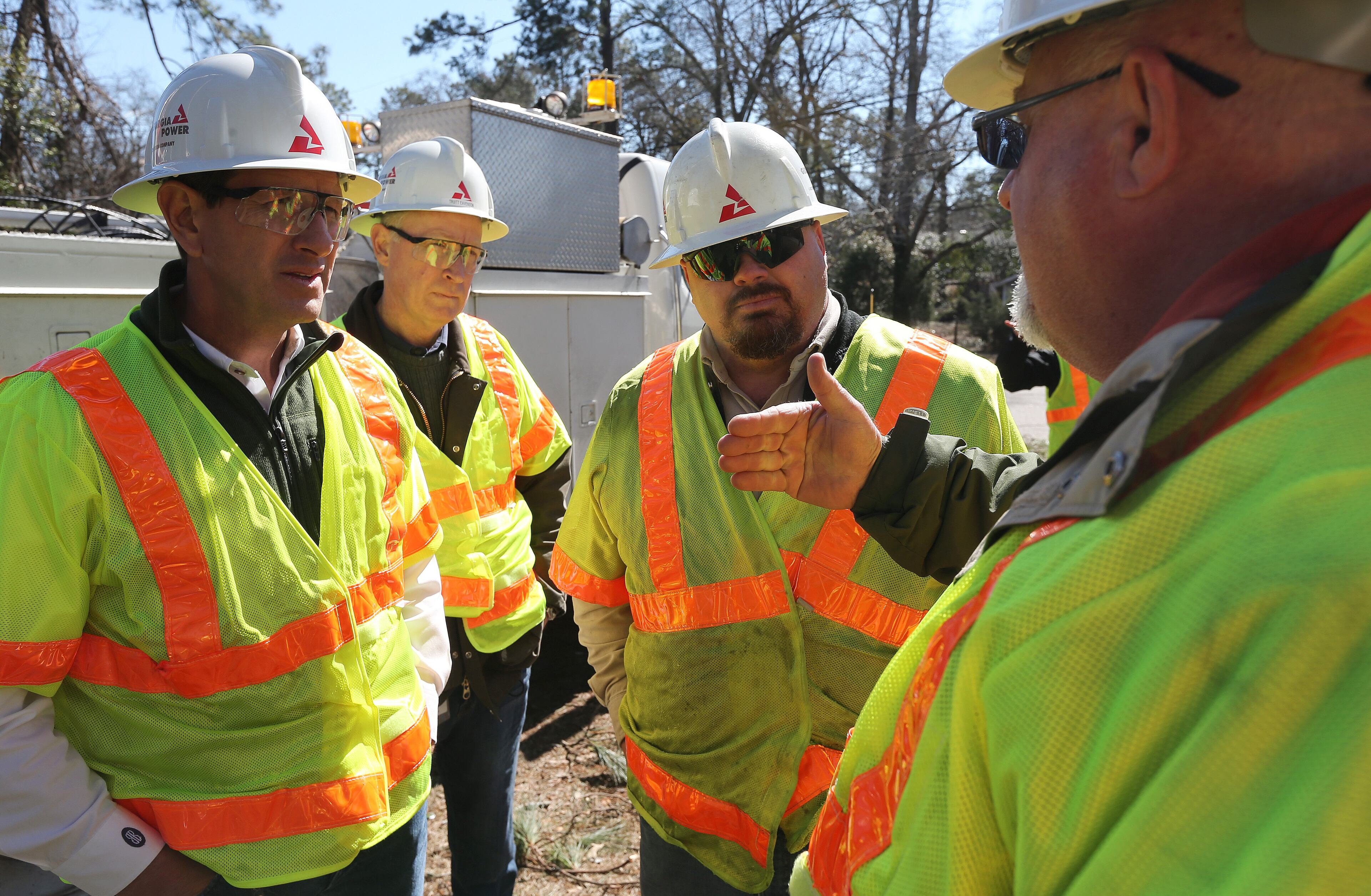 Georgia Power President and CEO Paul Bowers, from left, East Region Vice President Truitt Eavenson, Crew Leader Tony Coody and Reliability Engineer Van Cochran talks about power restoration in a storm-damaged South Augusta neighborhood Saturday afternoon February 15, 2014. The company expected to have power restored to 95% of customers by midnight Saturday. BEN GRAY / BGRAY@AJC.COM