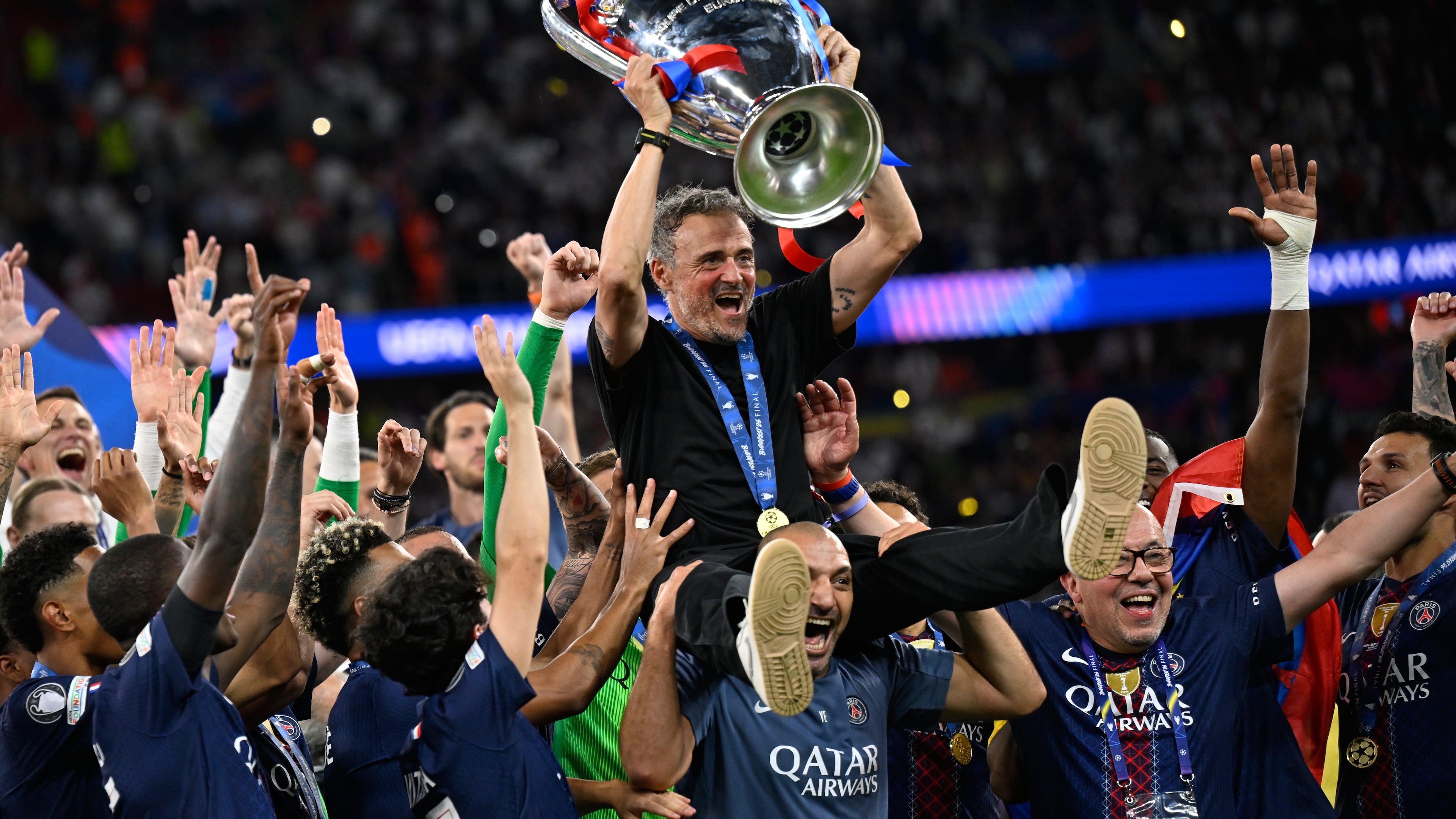 PSG's head coach Luis Enrique, top, celebrates with players after winning the Champions League final soccer match against Arsenal in Budapest, Hungary, Saturday, May 30, 2026. (AP Photo/Denes Erdos)