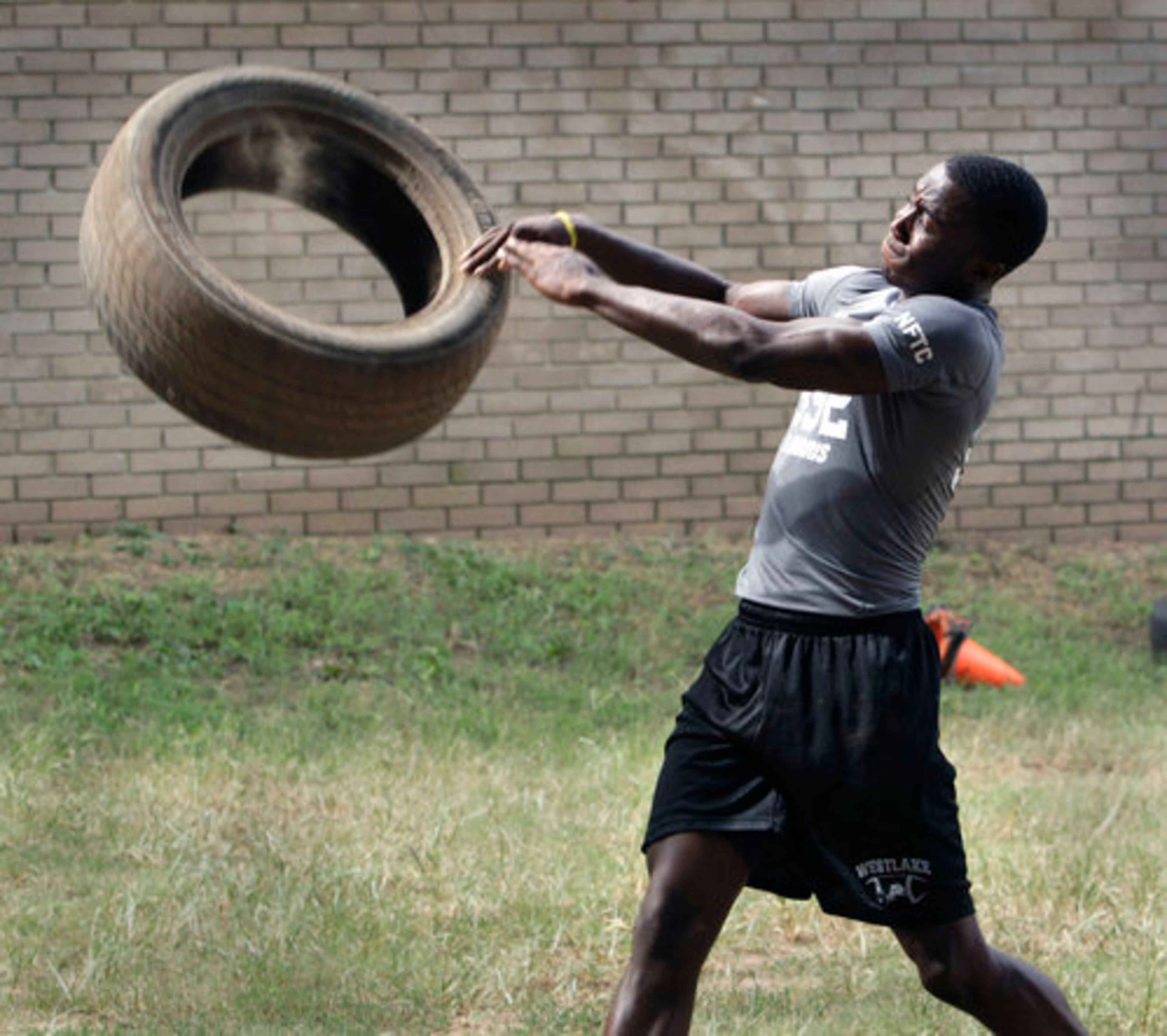 Ronnie Harris II throws tires as part of his workout with Jay Nears.