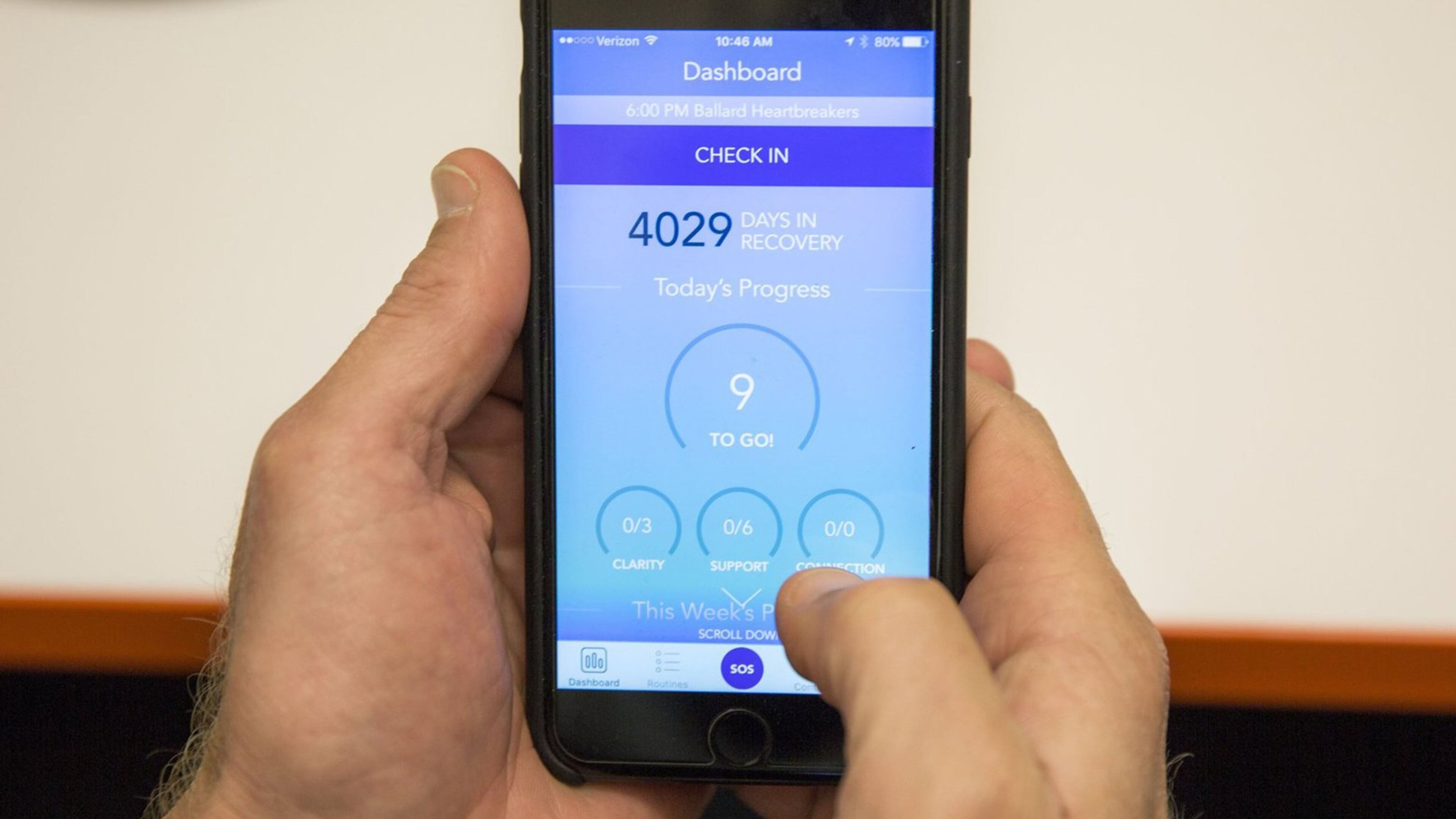 Murphy Jensen, of WEconnect, shows how the dashboard in the mobile app works. (Bettina Hansen/Seattle Times/TNS)
