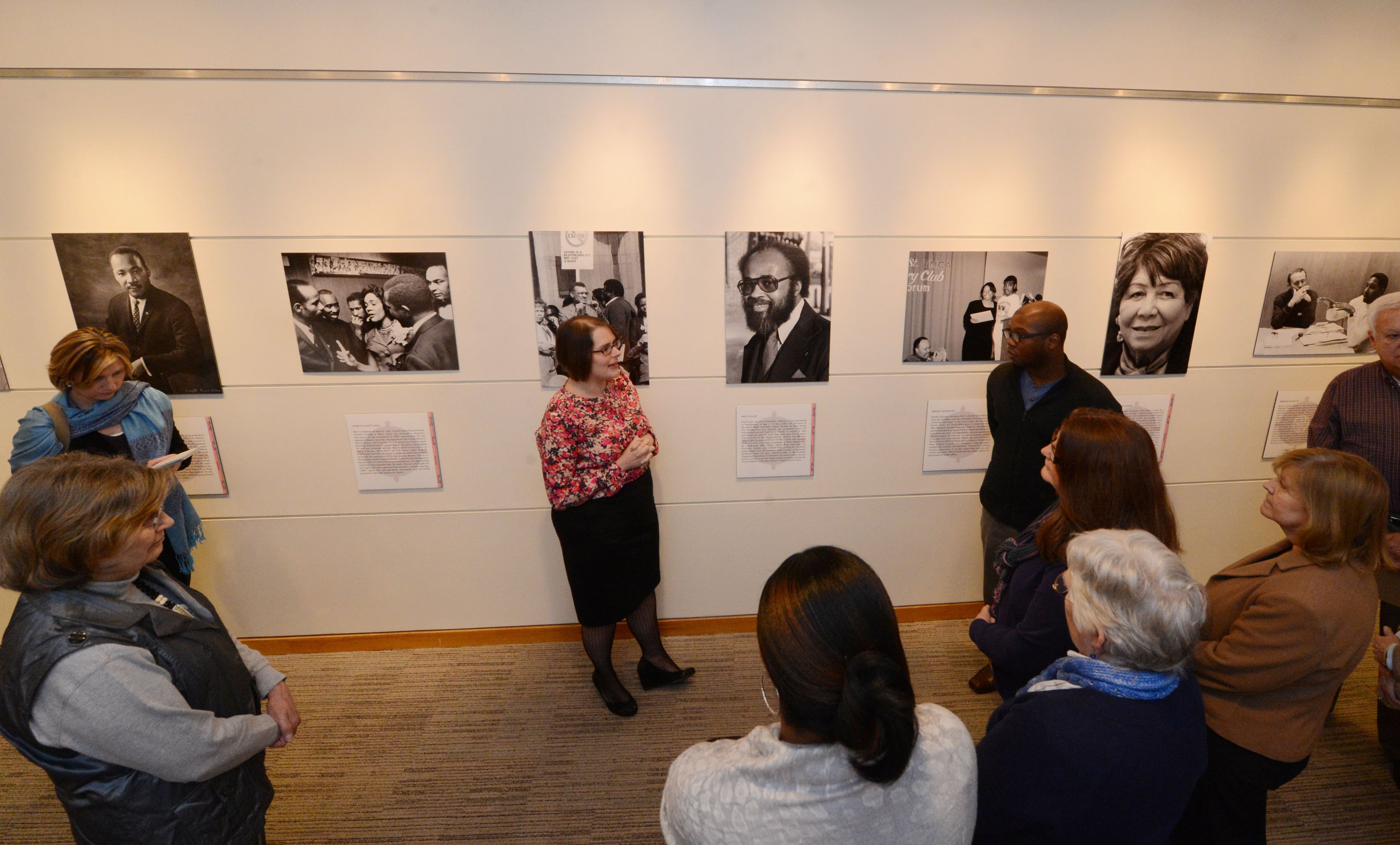 Co-curators Sarah Quighley (left) and Michael Ra-Shon Hall discuss the photos in the exhibition.