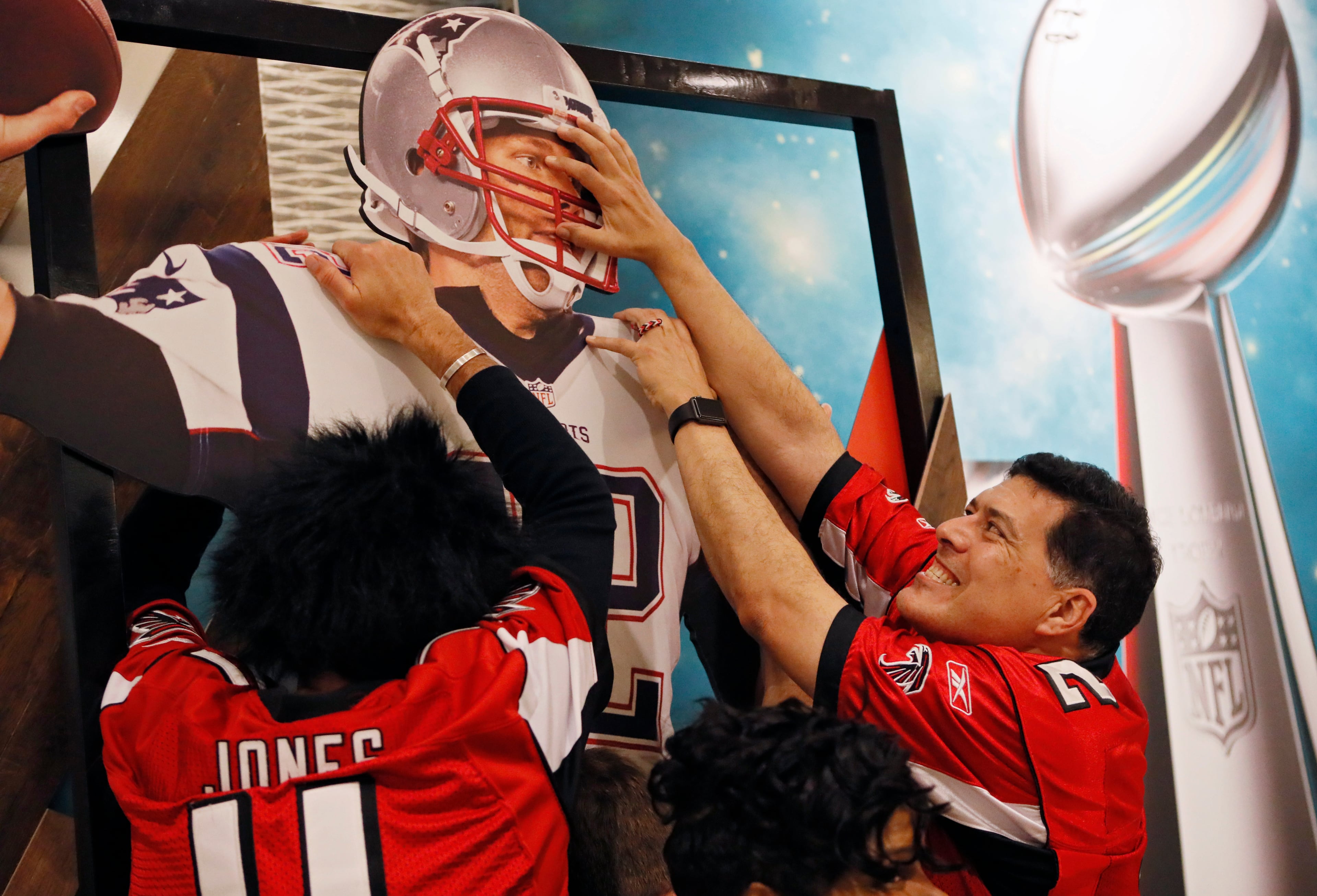 Feb. 4, 2017 - Houston - Andy Shearer (left) and Leon Shooter have fun and pose for photos by large cardboard displays of Matt Ryan and Tom Brady in the lobby of the Marriott Marquis Hotel in Houston. Their group drove to Houston in an RV for the game. Activity around the NFL Experience and the George R. Brown Convention Center on Saturday Feb. 4, 2017, in Houston. BOB ANDRES /BANDRES@AJC.COM