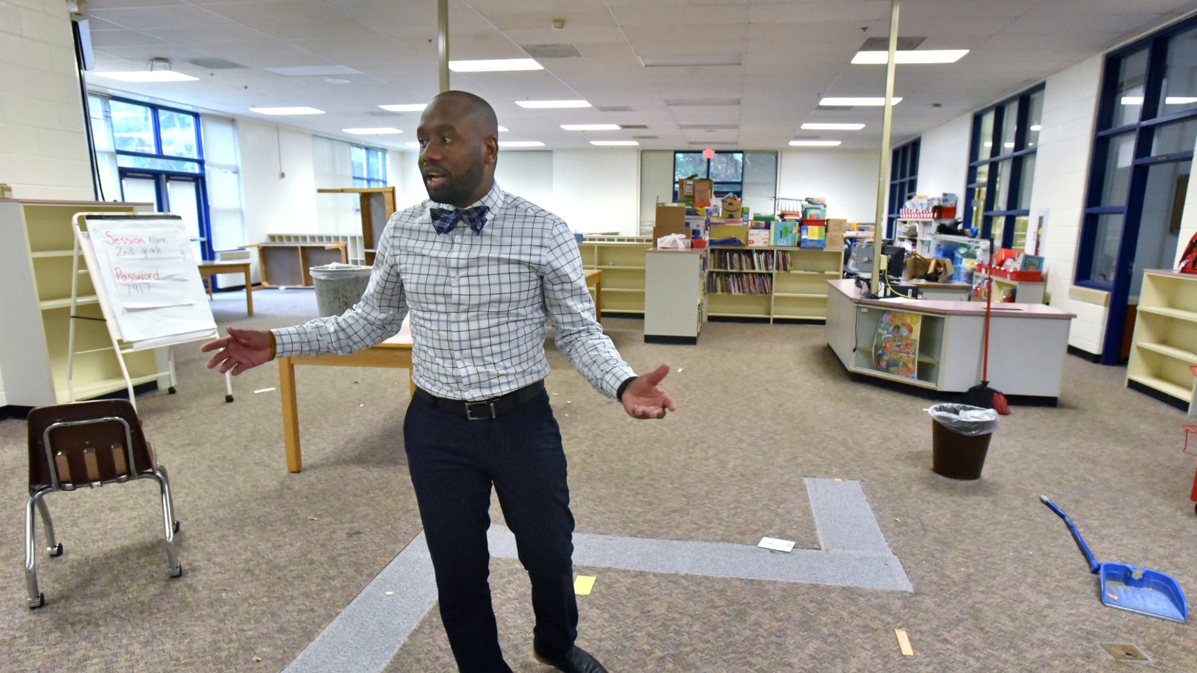 Davion Lewis, executive director, shows off the library of Latin College Preparatory School in East Point on Friday, June 29, 2018. Latin College Prep recently purchased the former Oak Knoll Elementary from Fulton County Schools. The school building has and will continue to house the schools that had been named Latin College Prep (a middle school) and Latin Grammar (an elementary school). Now that the charter school has ownership of the property, they will be doing some renovation work to it - including beefing up security, adding an outside gate, and doing some classroom refreshing. HYOSUB SHIN / HSHIN@AJC.COM