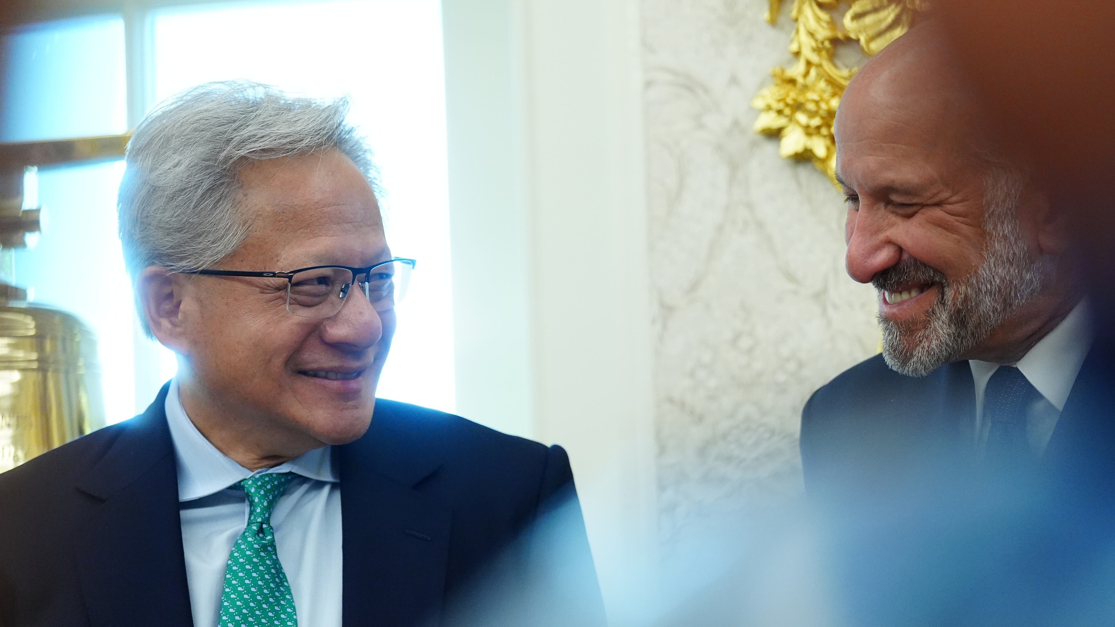 NVIDIA CEO Jensen Huang talks with Commerce Secretary Howard Lutnick as President Donald Trump speaks in the Oval Office of the White House about Dulles International Airport modernization, Wednesday, July 29, 2026, in Washington. (AP Photo/Julia Demaree Nikhinson)