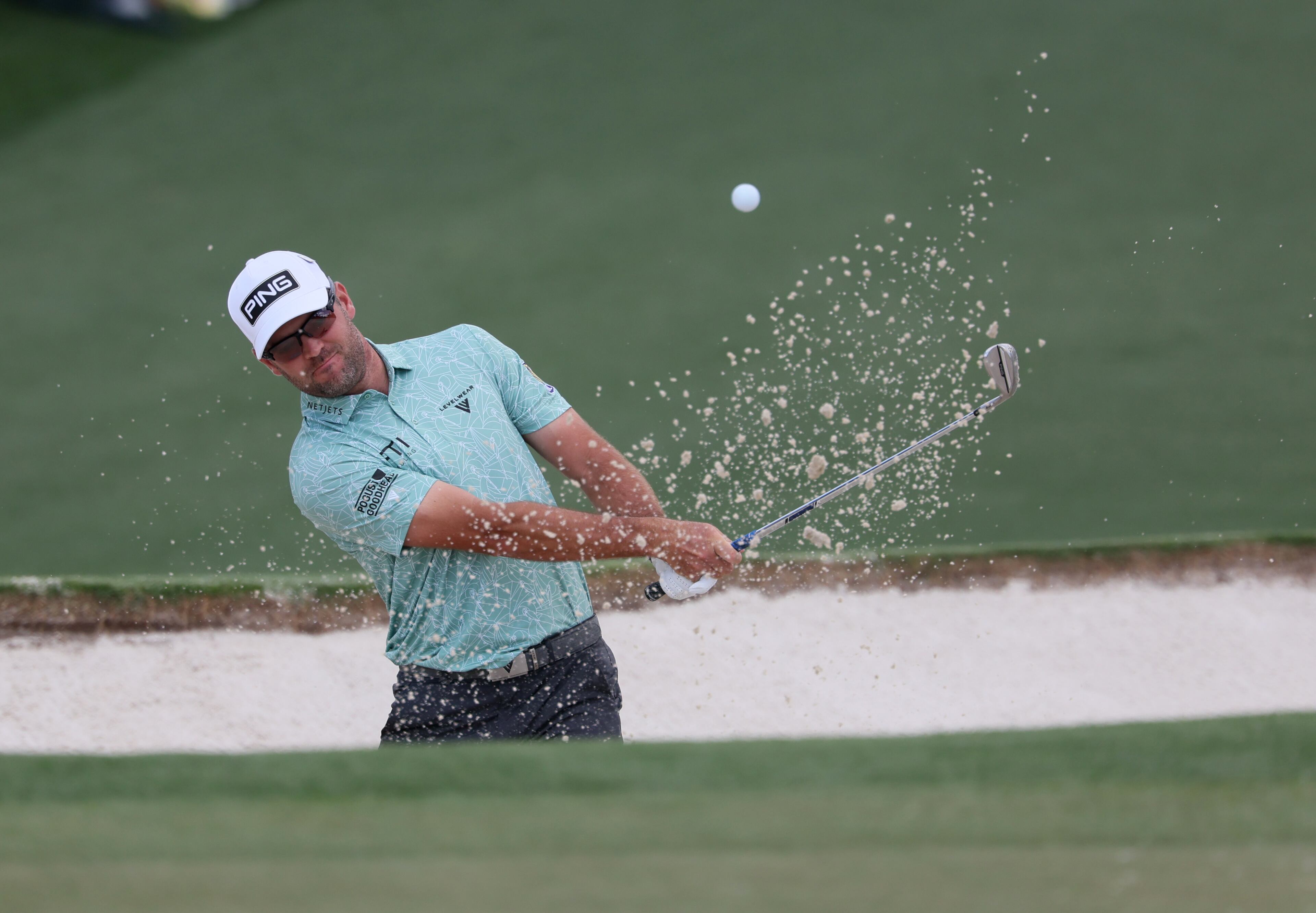 Corey Conners hits out of bunker on second hole during second round of the Masters golf tournament, at Augusta National Golf Club, Friday, April 11, 2025, in Augusta, Ga. (Jason Getz / AJC)