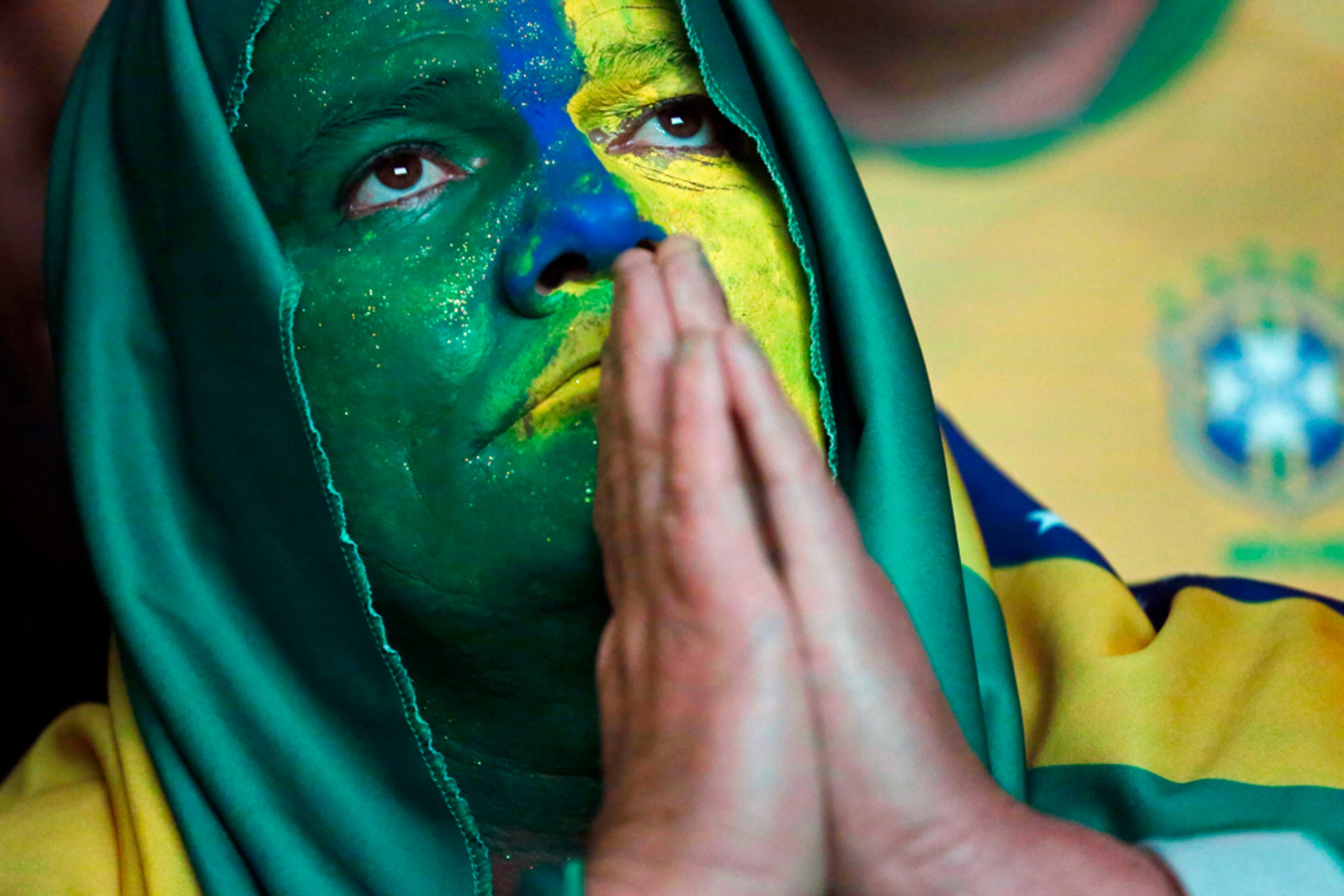 SOCCER CUP MATCHES--A Brazil soccer fan watches the final Confederations Cup soccer match between Brazil and Spain on a screen in downtown Sao Paulo, Brazil, Sunday, June 30, 2013. (AP Photo/Nelson Antoine)