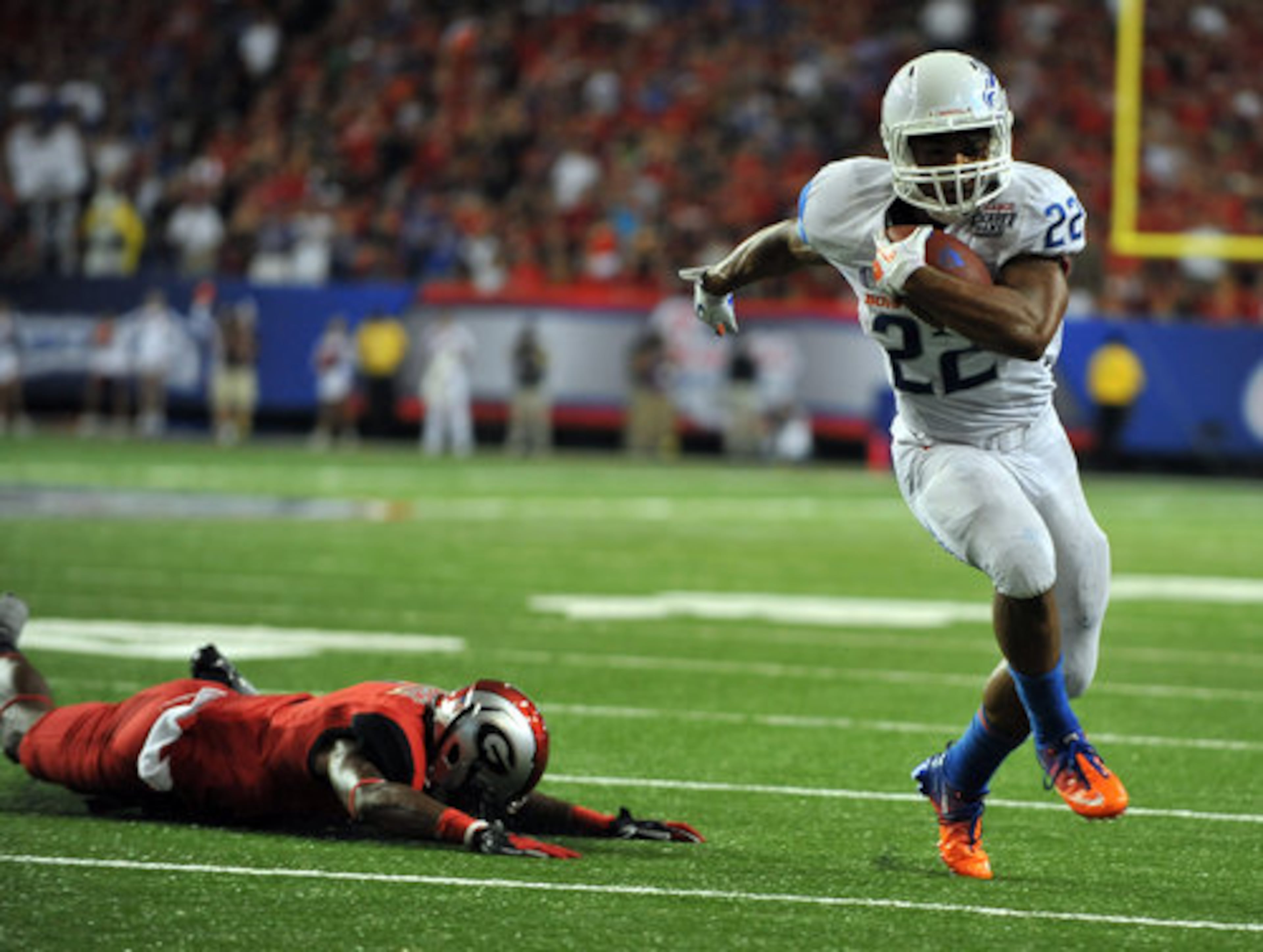 Boise State running back Doug Martin has a clear path to the endzone after stiff arming Georgia defender Branden Smith.