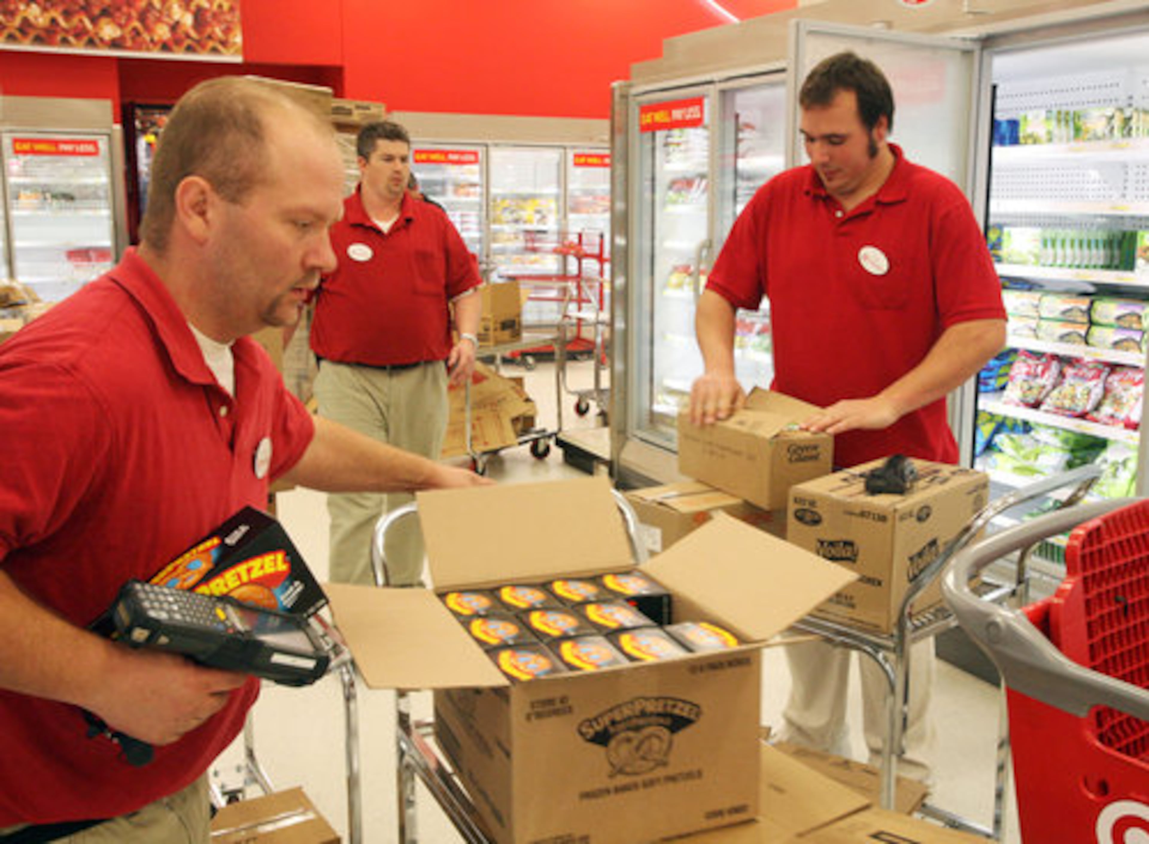 David Frady, Charles Morgan & Richard Raysick stock the food coolers at the new Super Target store which is scheduled to open on March 8th at the Canton Marketplace.