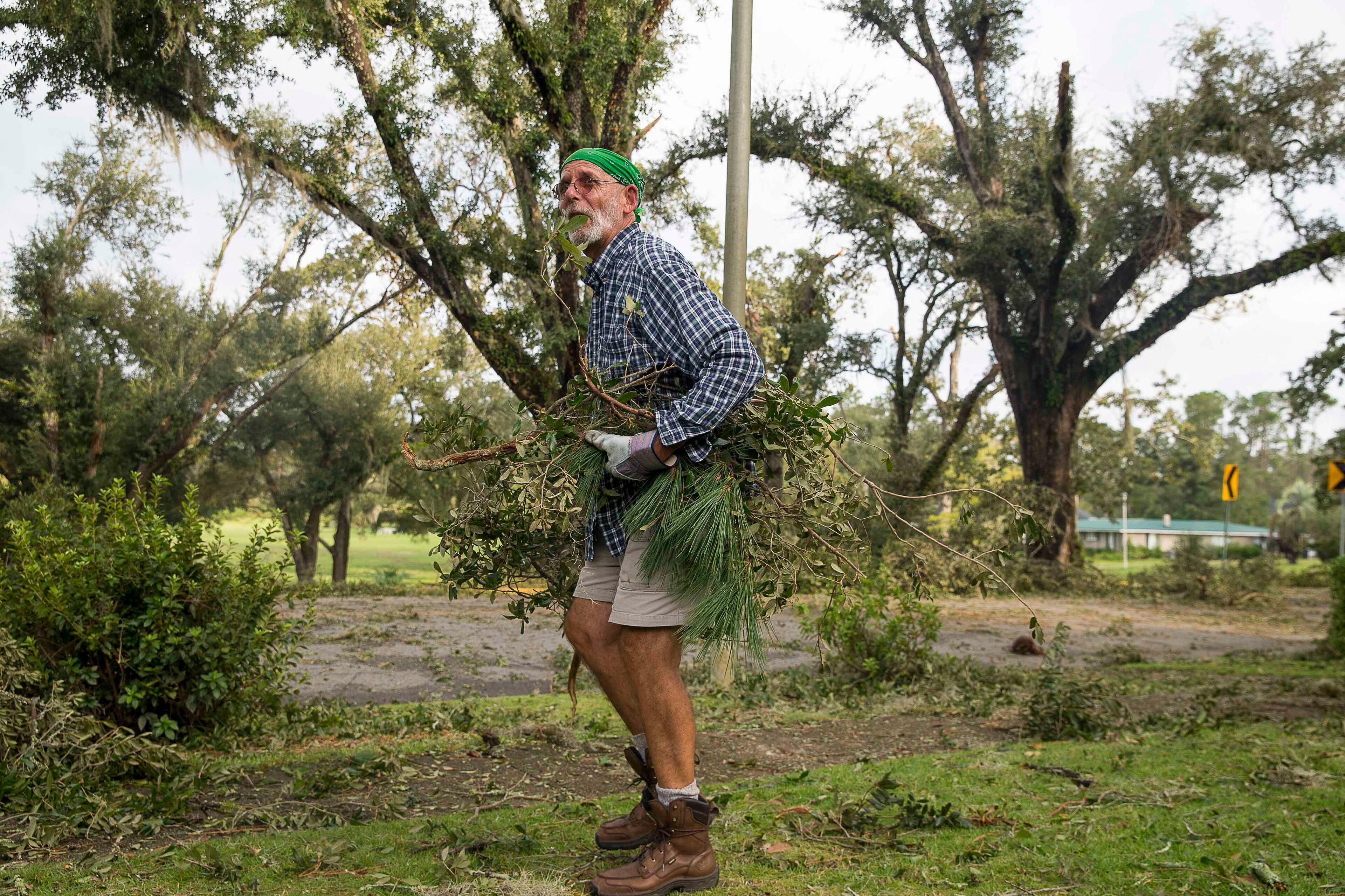 10/11/2018 -- Albany, Georgia -- Ron Smith cleans up broken limbs and debris from his yard a day after Hurricane Michael passed through Albany, Thursday, October 11, 2018. (ALYSSA POINTER/ALYSSA.POINTER@AJC.COM)
