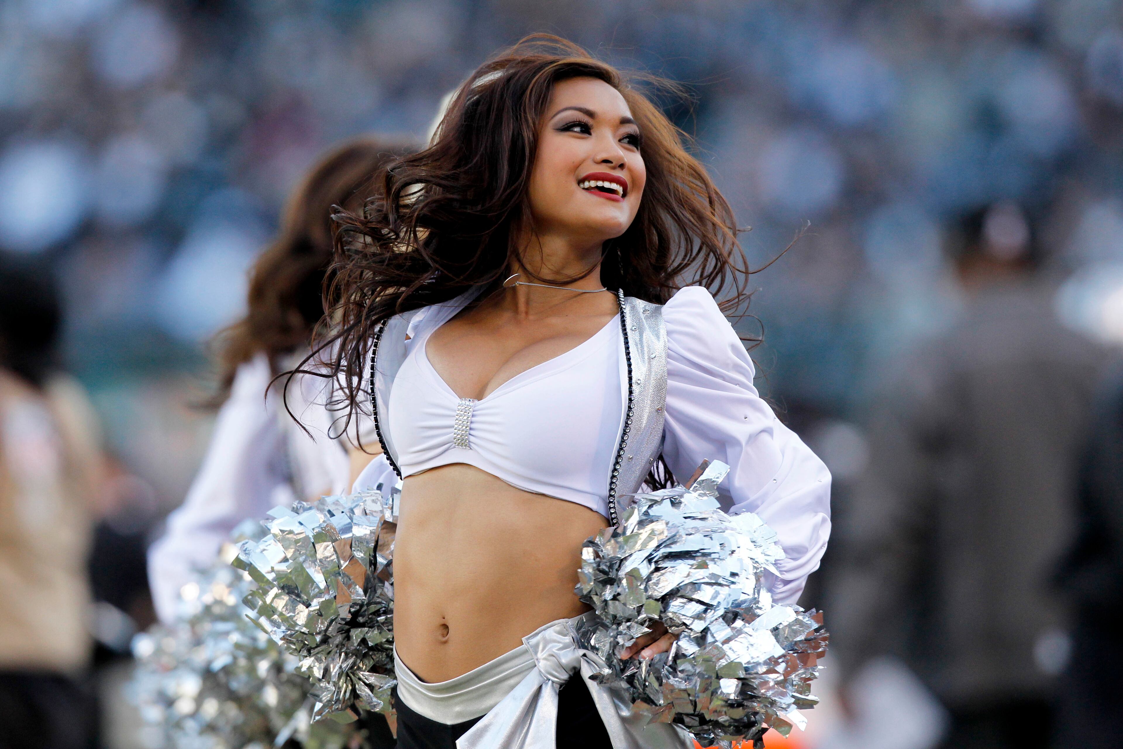 An Oakland Raiders cheerleader from the raiderettes squad performs during a timeout against the Tennessee Titans in the third quarter at O.co Coliseum. The Titans defeated the Raiders 23-19. Mandatory Credit: Cary Edmondson-USA TODAY Sports