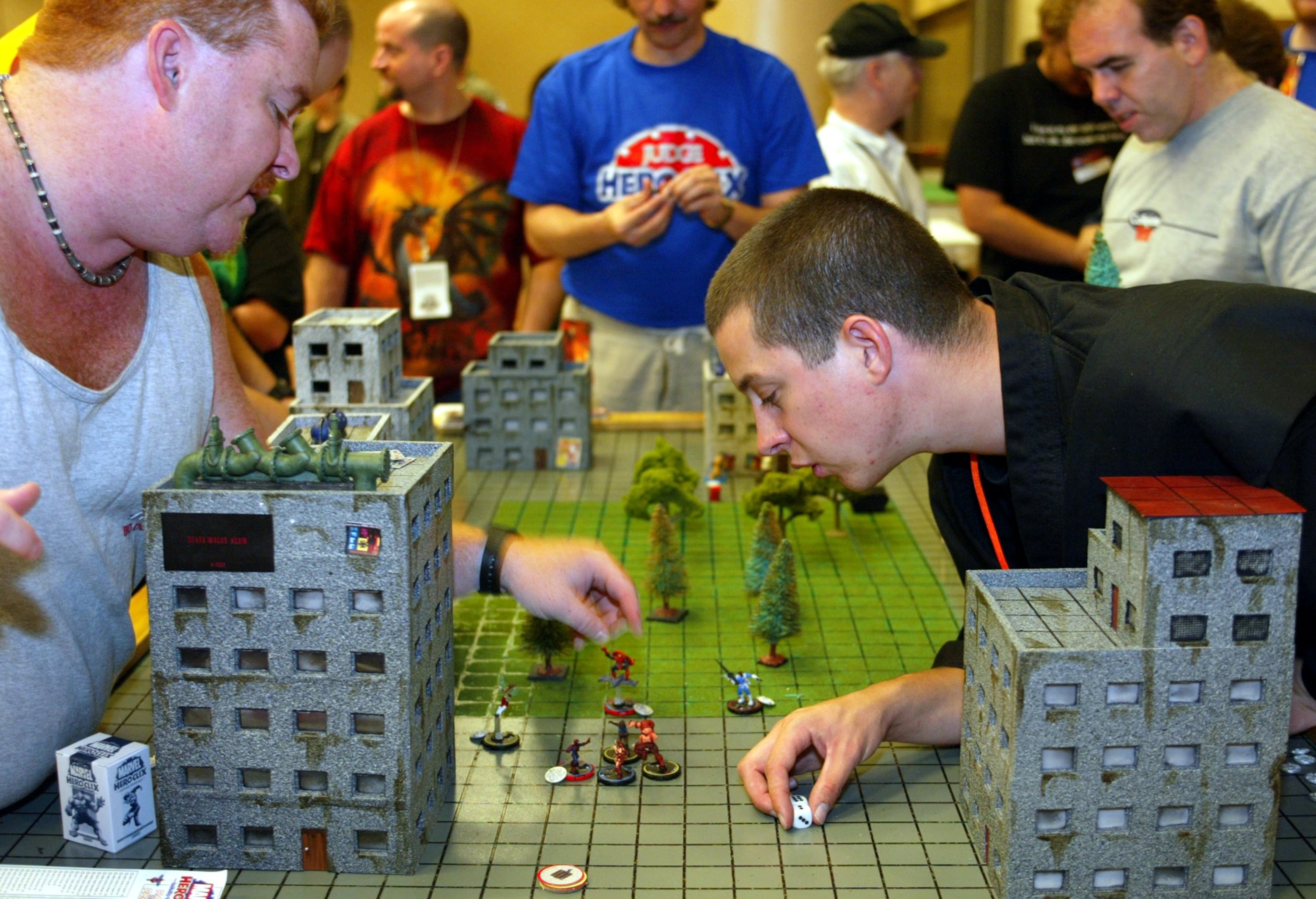 (From left) Larry Noble plays a game of Marvel HeroClix with Otto Schmidt at the Dragon Con convention in the Hyatt Regency hotel in downtown Atlanta on Aug. 30, 2002. (Phil Skinner/AJC).