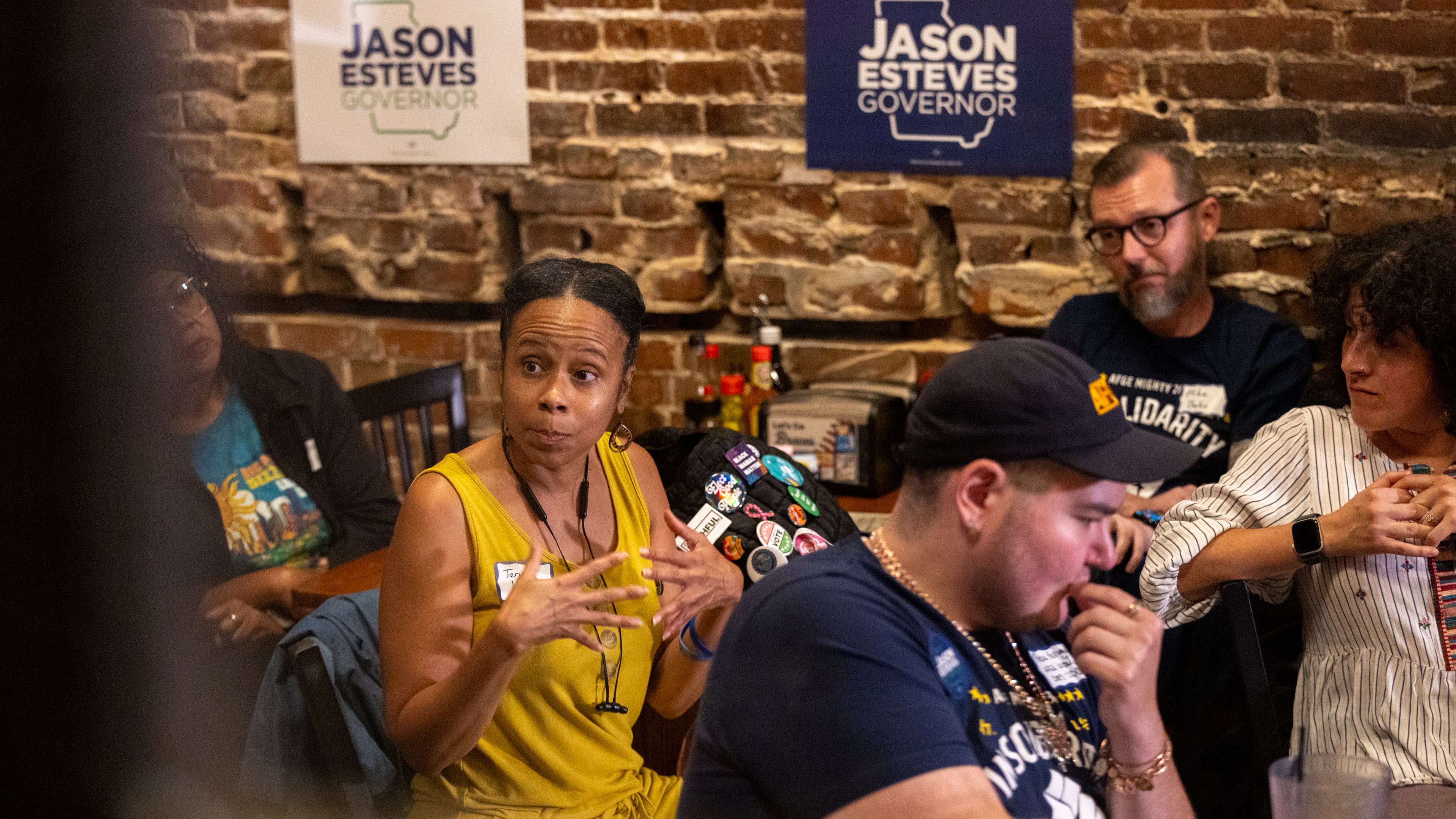 Teri Larkins (left), a furloughed CDC employee, speaks during a roundtable with other furloughed employees hosted by Democratic gubernatorial candidate Jason Esteves at Manuel’s Tavern in Atlanta on Friday, October 3, 2025. (Arvin Temkar/AJC)