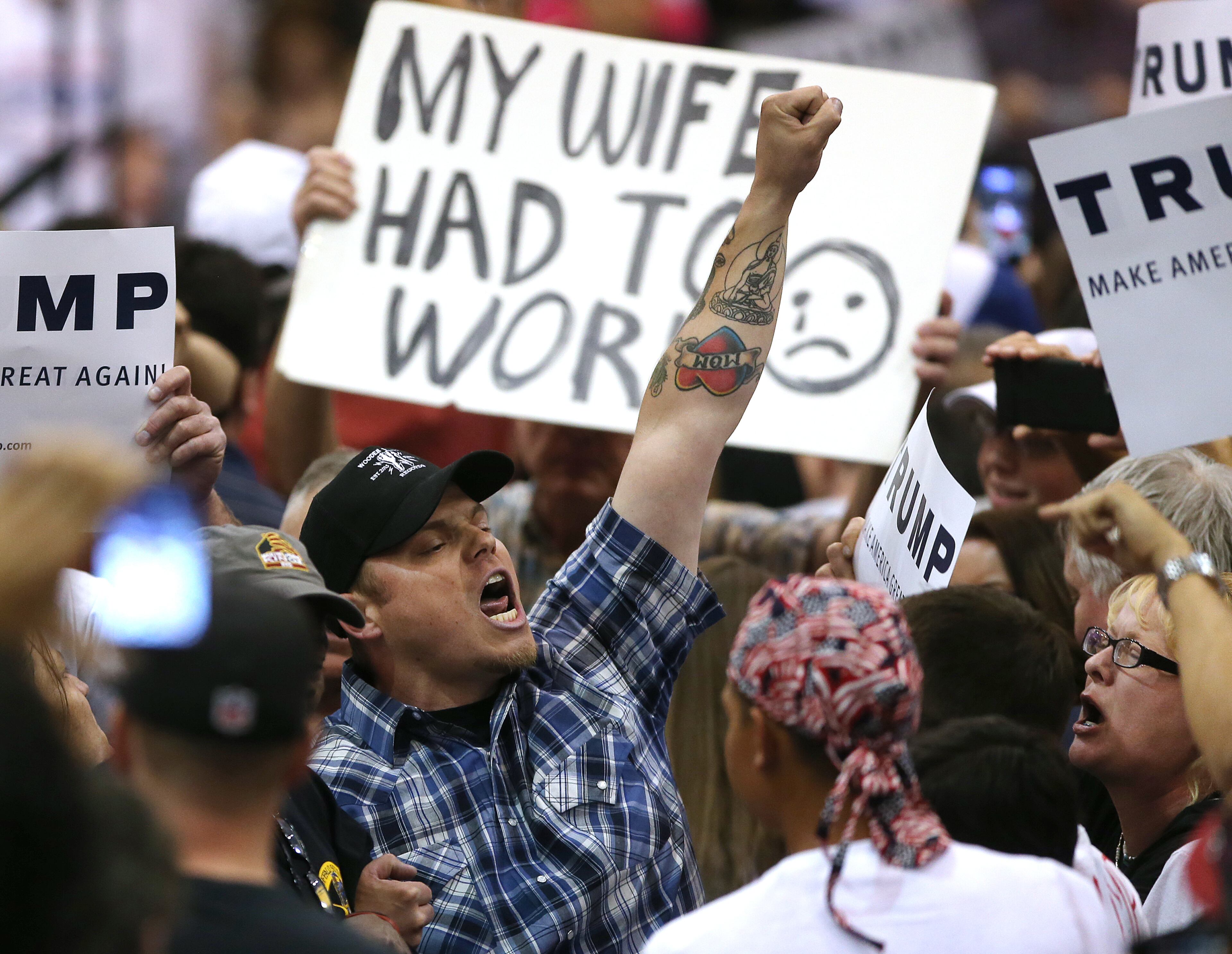 Protester Austin Counts is escorted out of Republican presidential candidate Donald Trump's rally at the Tucson Arena in downtown Tucson, Ariz., Saturday, March 19, 2016. (Mike Christy/Arizona Daily Star via AP)