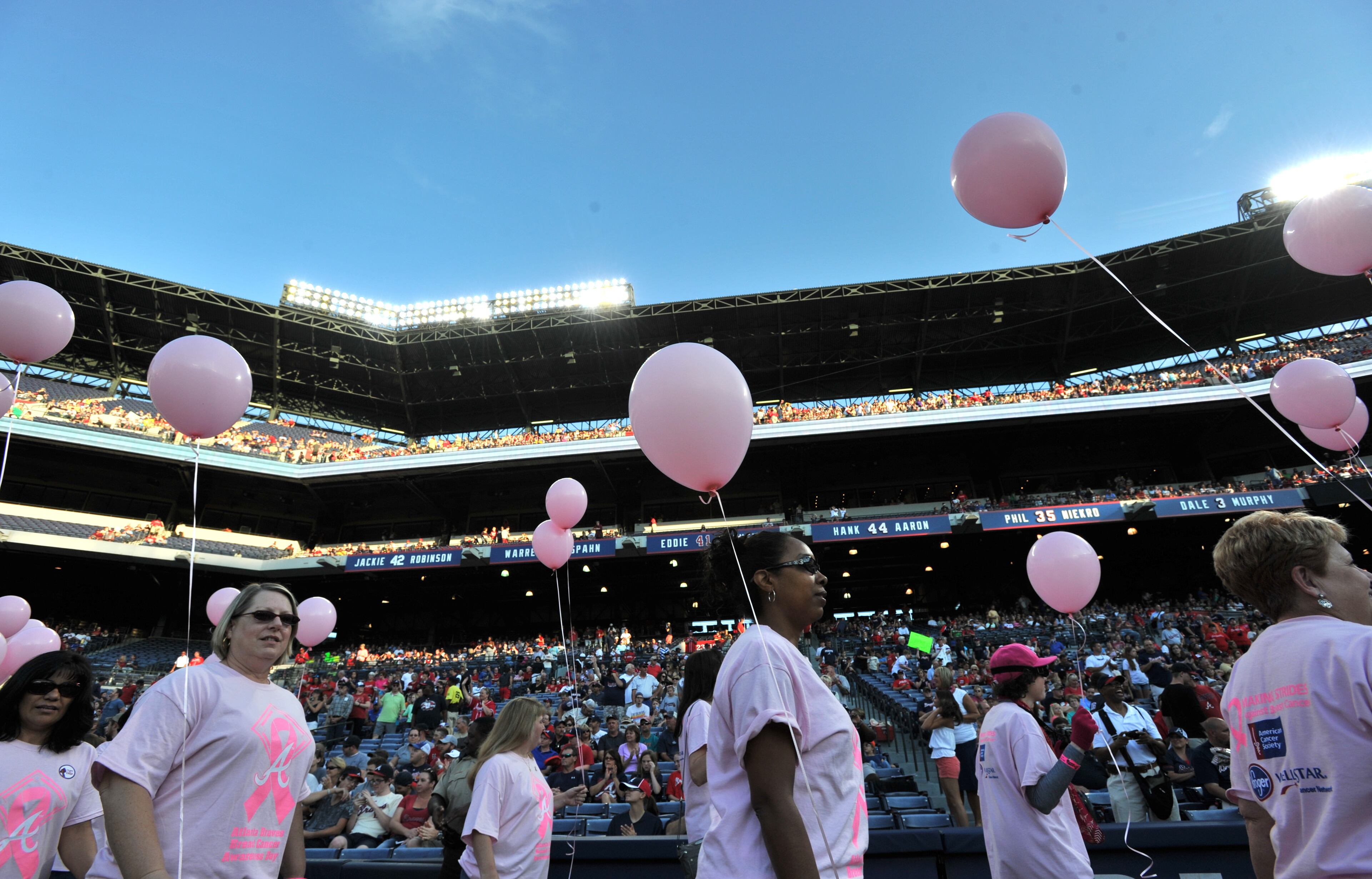 About 300 survivors and their families marched on field during "A Walk in the Park," a pregame ceremony before Atlanta Braves game against the San Diego Padres at Turner Field on Saturday, September 14, 2013. This season, the Braves, WellStar Health System, Kroger and the American Cancer Society Making Strides Against Breast Cancer teamed up for the 7th annual Braves Breast Cancer Awareness Day. The day-long celebration of survivorship honors those who have courageously battled breast cancer, and raised awareness and funds to support research, education and advocacy for cancer patients and their families throughout metro Atlanta.