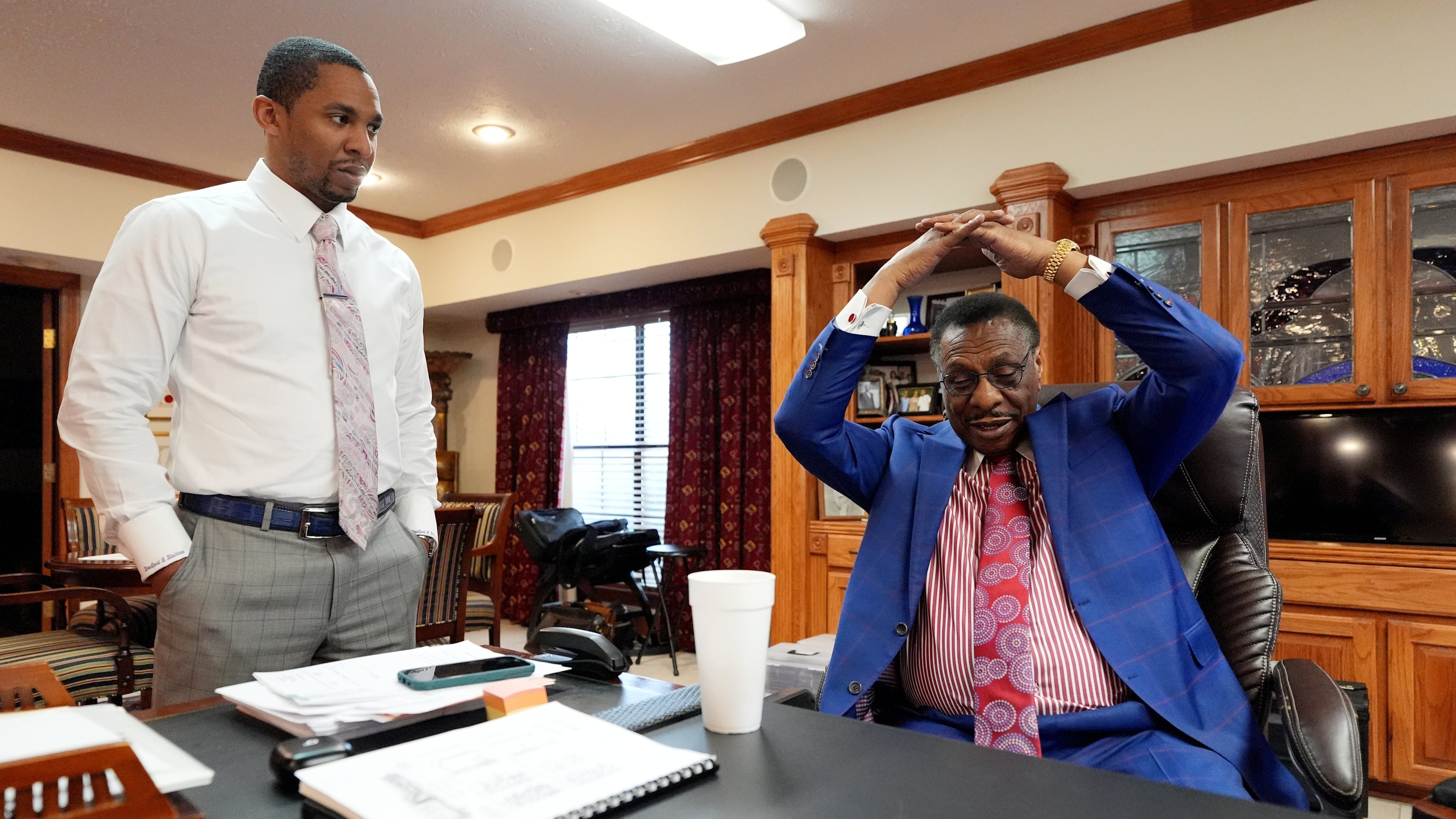 Attorney Edward Blackmon Jr., 78, a civil rights attorney and a former state representative, right, demonstrates how he and other civil rights marchers were taught how to protect themselves if physically set upon by lawmen to his son State Sen. Bradford Blackmon, D-Canton, in Canton, Miss., Friday, May 1, 2026. (AP Photo/Rogelio V. Solis)