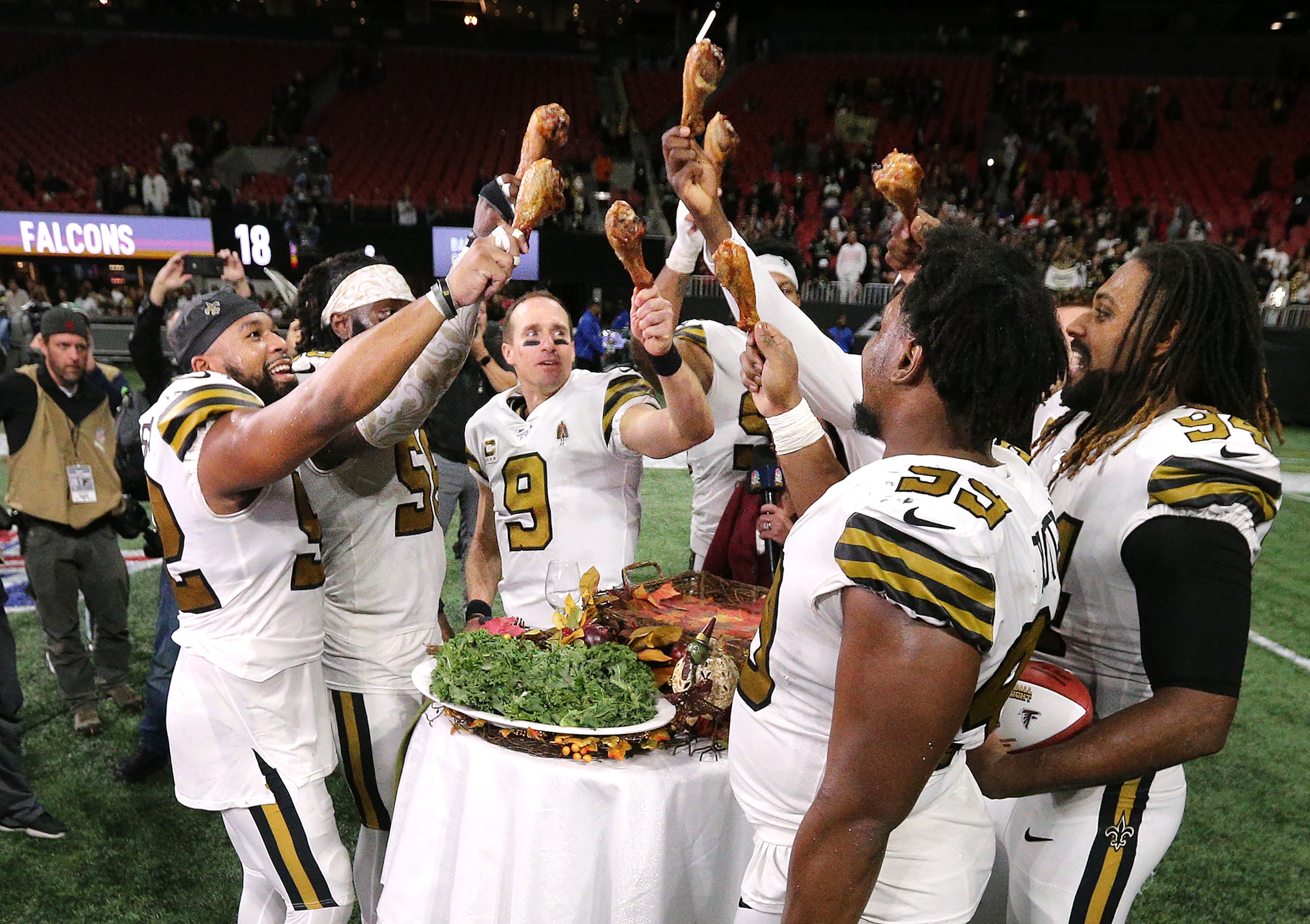 New Orleans Saints quarterback Drew Brees and teammates celebate a 26-18 victory over the Atlanta Falcons with turkey legs on Thanksgiving Day while clinching the NFC South in a NFL football game on Thursday, November 28, 2019, in Atlanta. Curtis Compton/ccompton@ajc.com