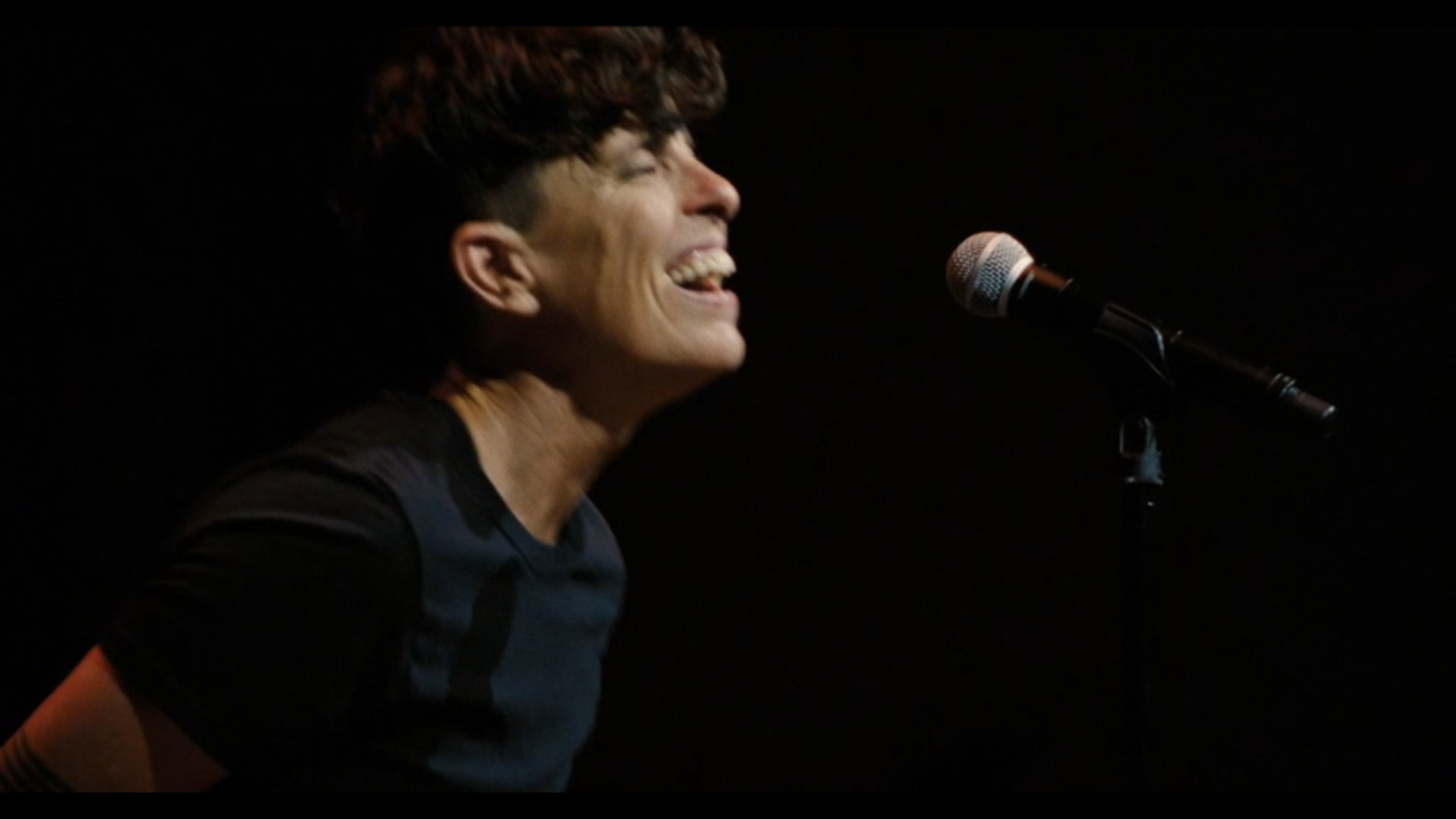 Poet Andrea Gibson expresses pure joy performing in May 2024 in Denver, their final live show taped for Apple TV+'s "Come See Me in the Good Light." (APPLE TV+ screenshot)